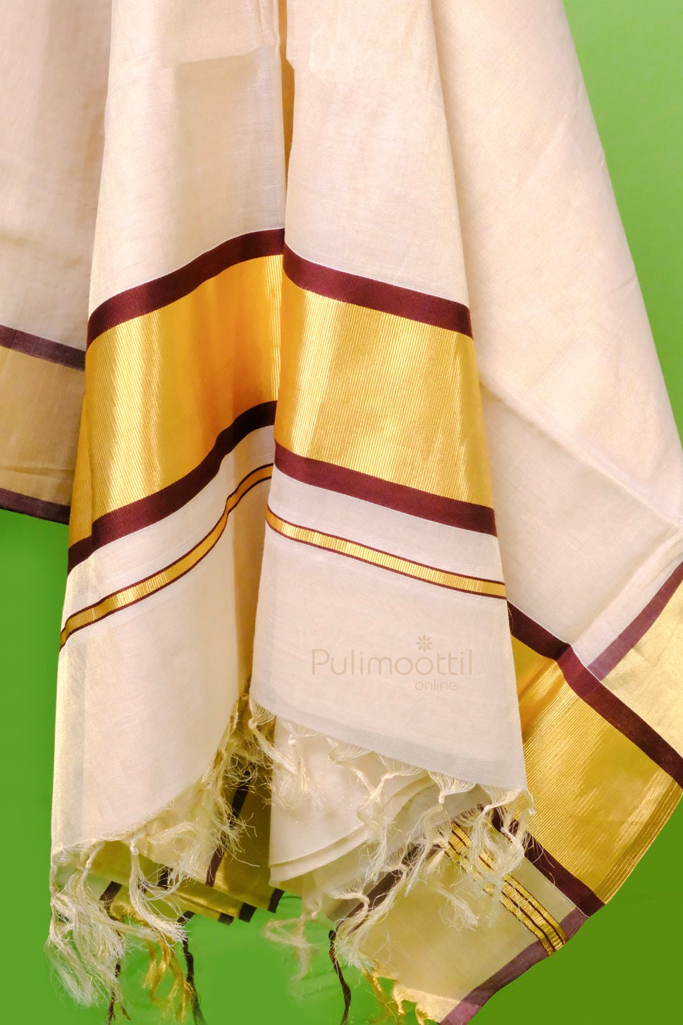 "Close-up of the Kerala kasavu mundu showing intricate maroon and golden borders with a soft woven texture and fringed hem.