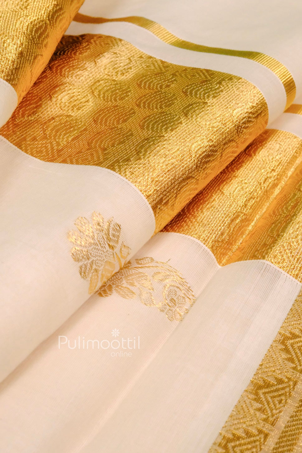 Close-up of the golden zari pallu with intricate patterns on an off-white Kerala saree, highlighting fine floral motifs.