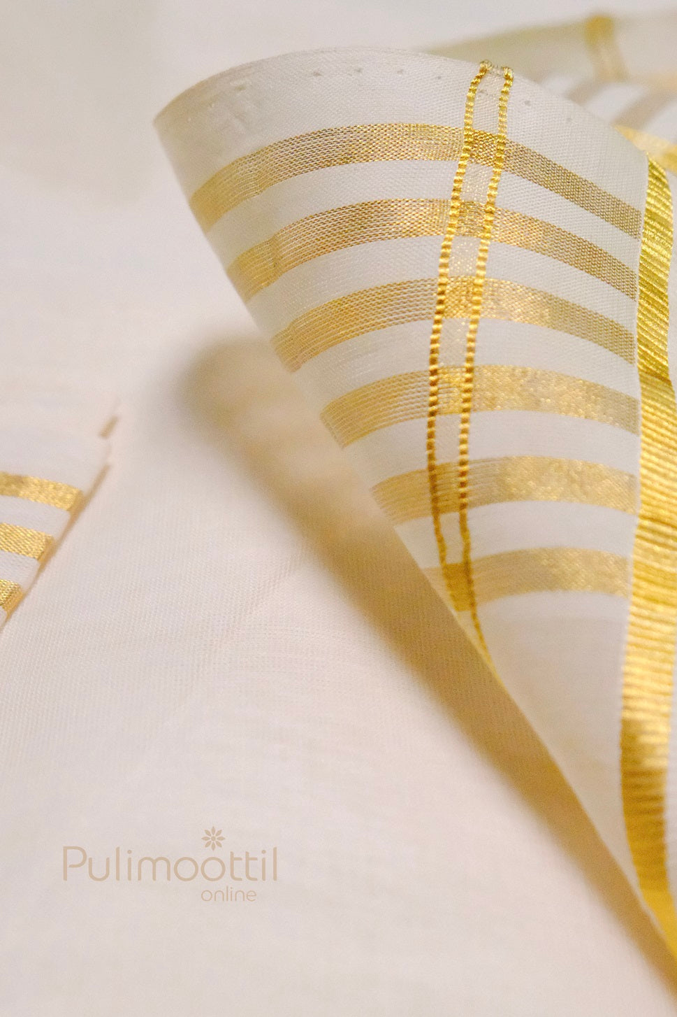 Golden zari border detail of Kerala kasavu saree showing fine weave and craftsmanship