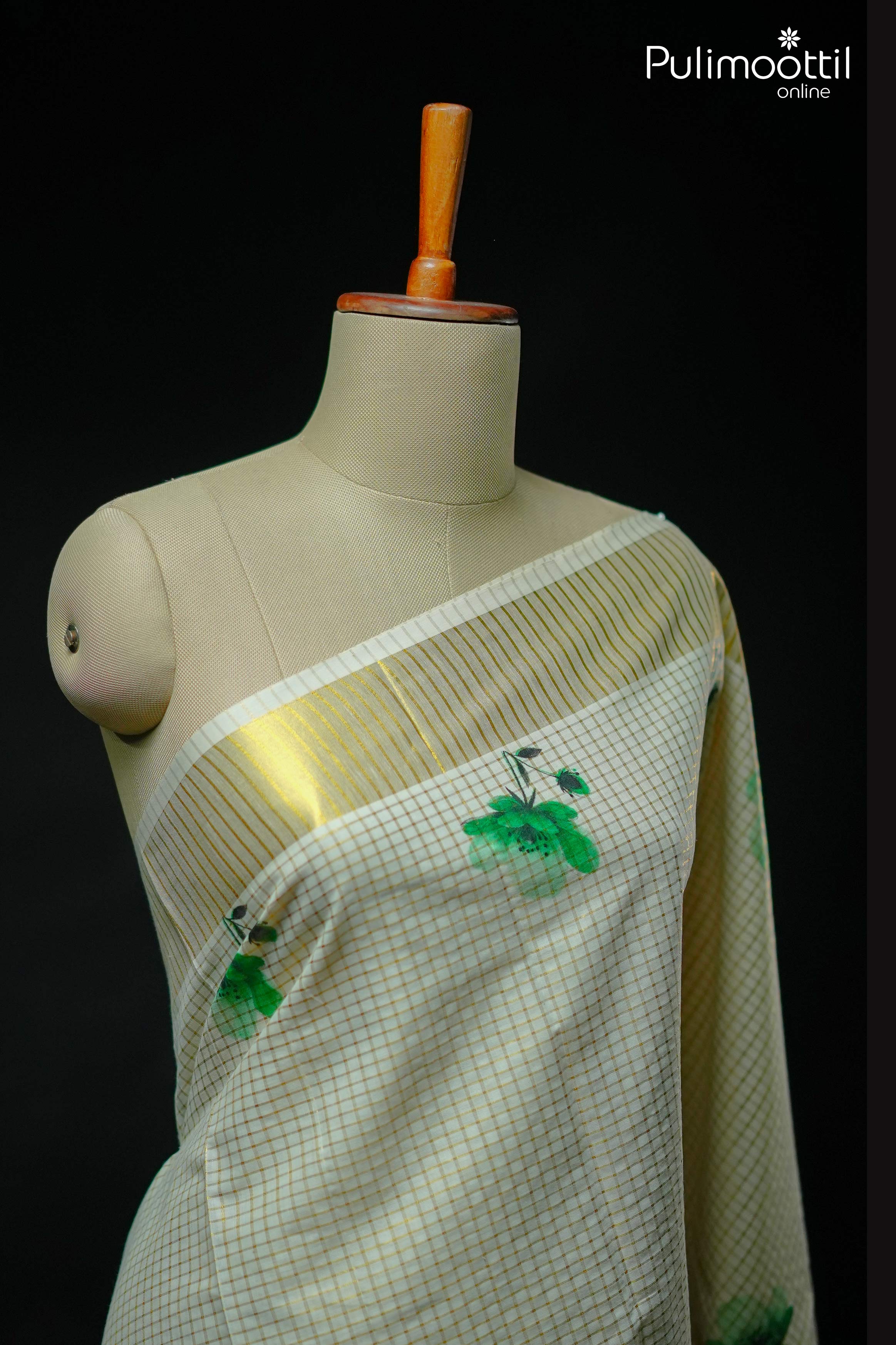 Cream Kerala tissue blouse piece with golden zari check pattern and shimmering gold striped border.