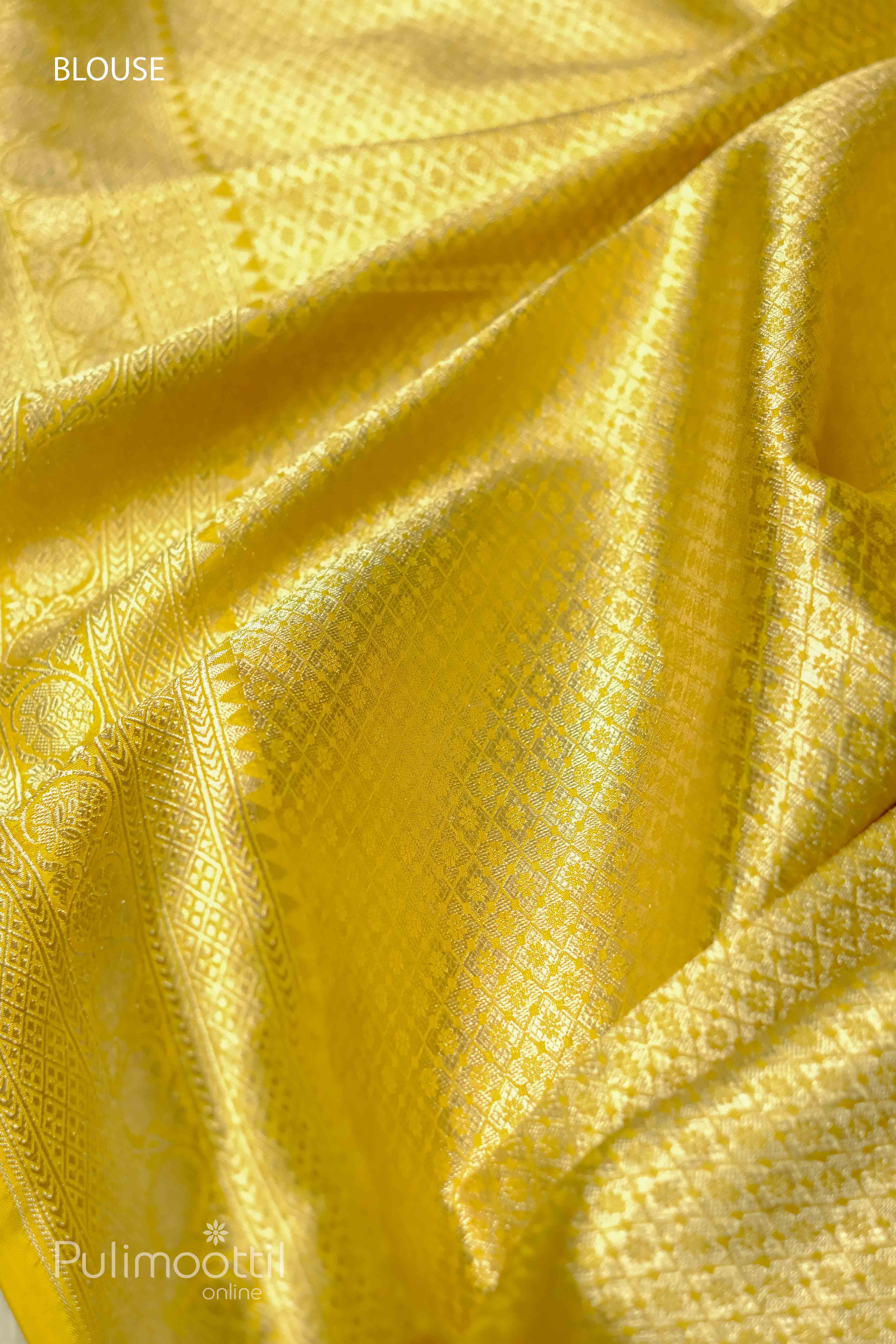 Lemon yellow pure Banarasi silk saree featuring intricate woven patterns and golden border, with a focus on the blouse area, perfect for weddings and festive occasions.