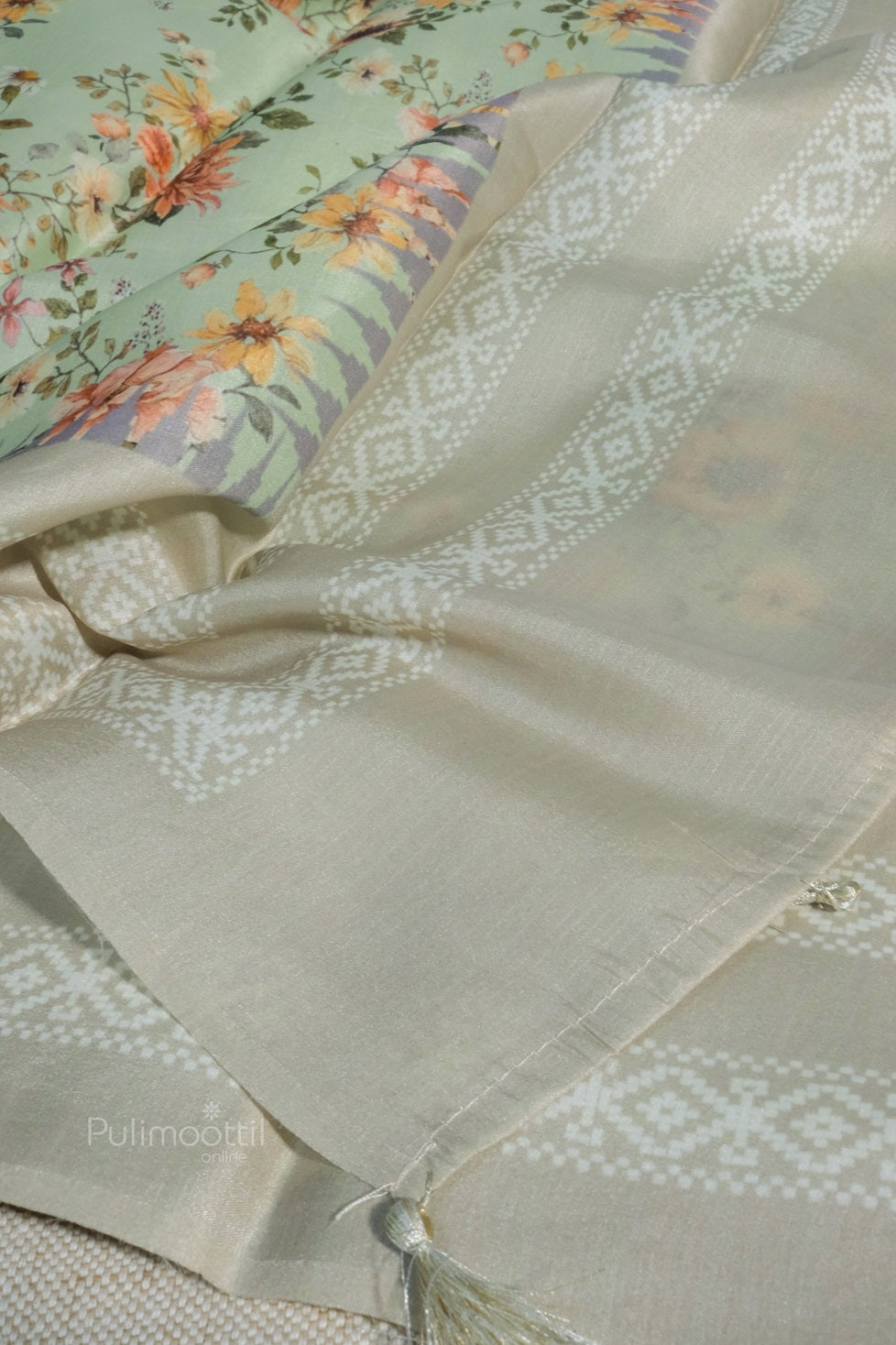 Light cyan silk saree arranged to show detailed border and part of the pallu design. Fabric texture and fall are highlighted clearly.