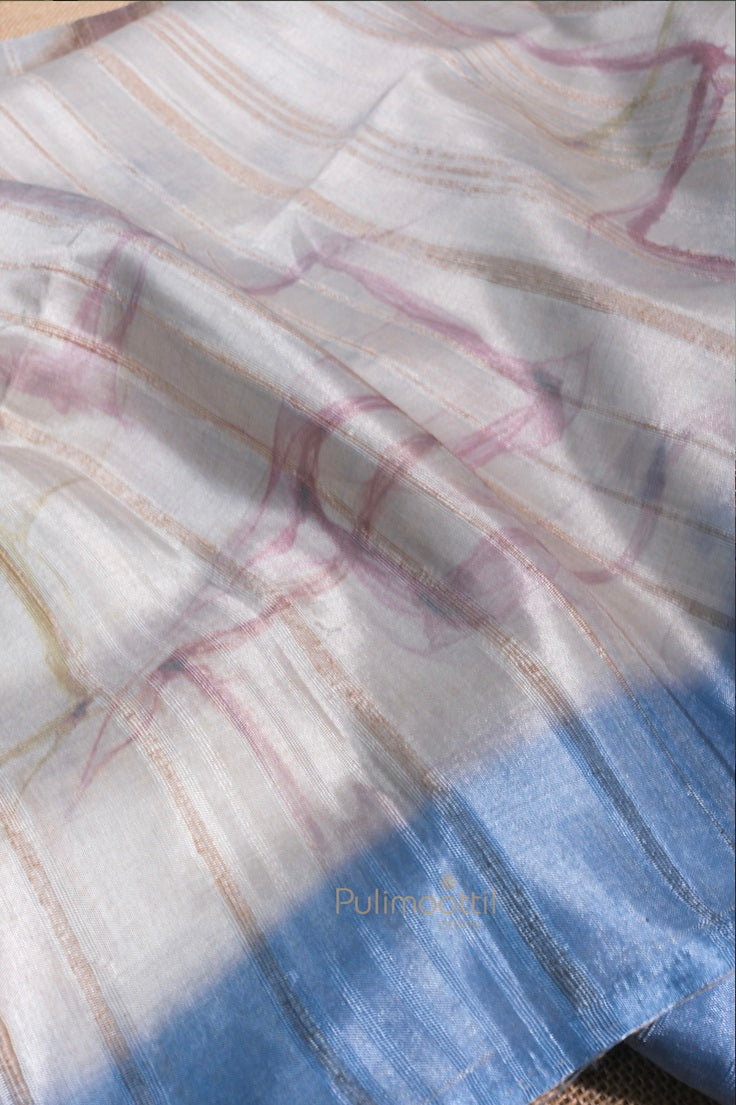 Elegant light gray and blue semi Tussar silk saree with delicate abstract patterns and smooth finish.