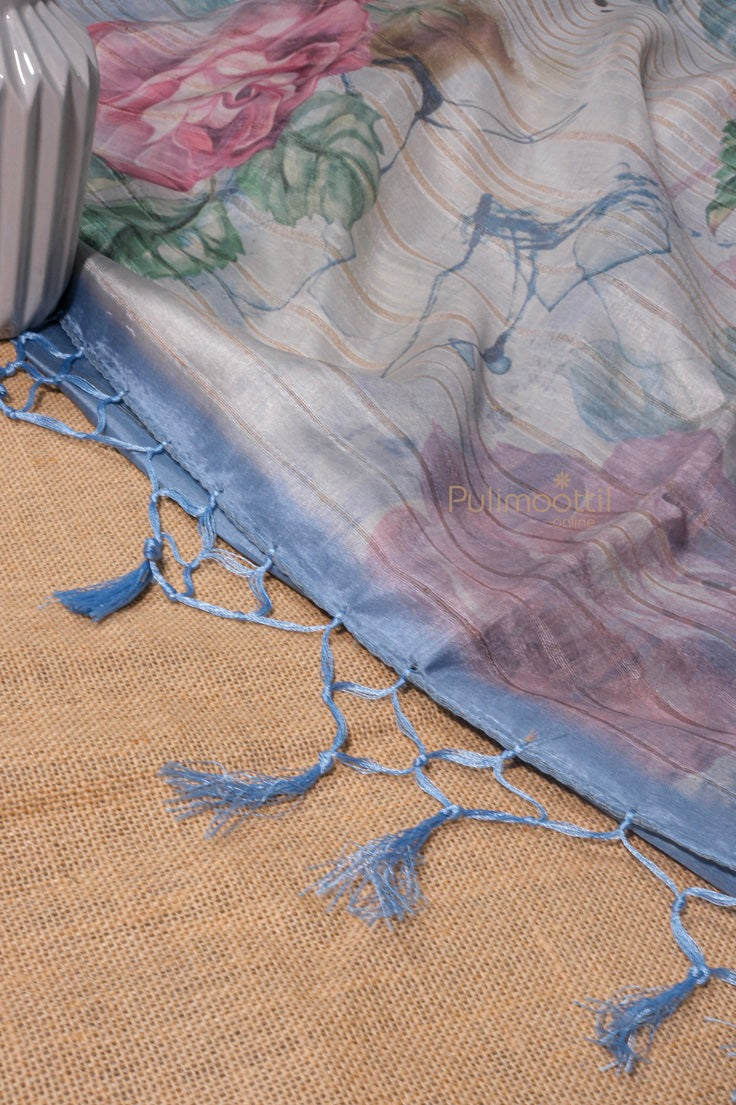 showing muthani of a tusser silk saree with floral print and showing tessels hanging down