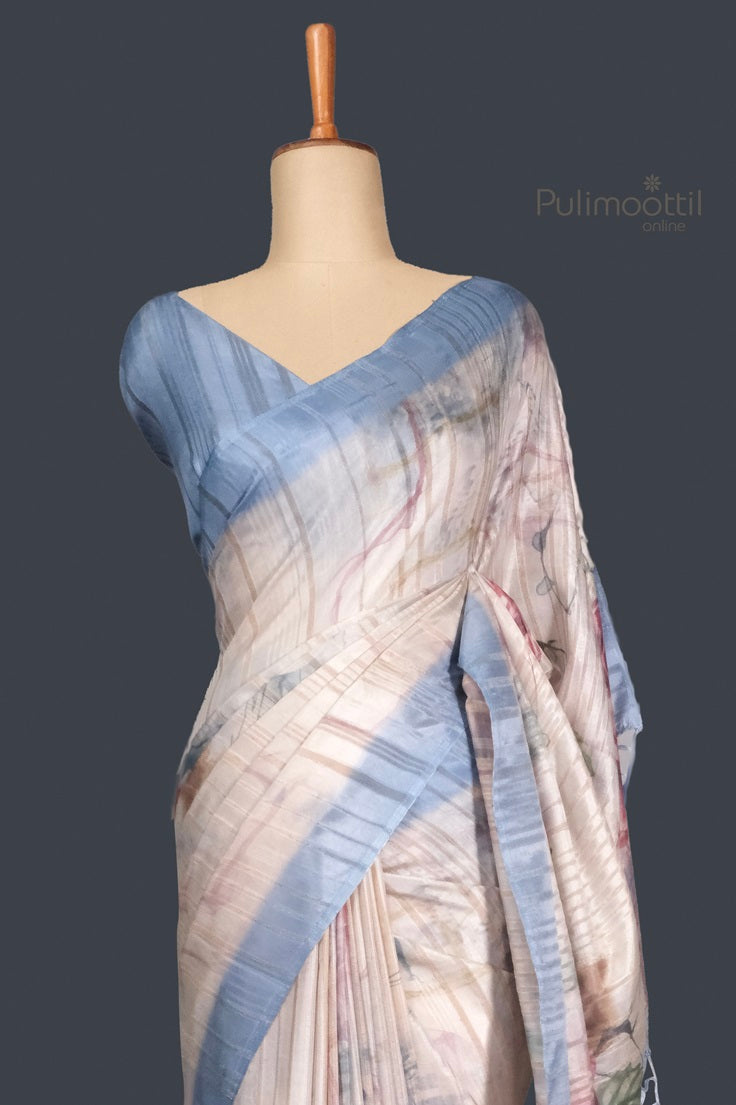 Full view of light gray and blue semi Tussar silk saree draped on mannequin, showcasing graceful fall and pastel hues.