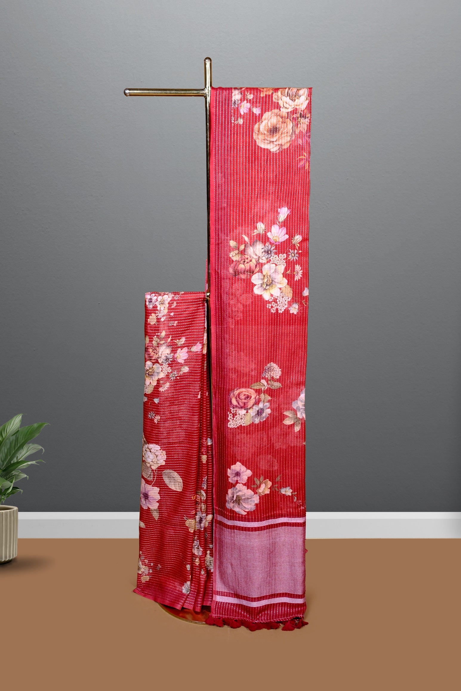 Full view of red floral saree displayed on a stand