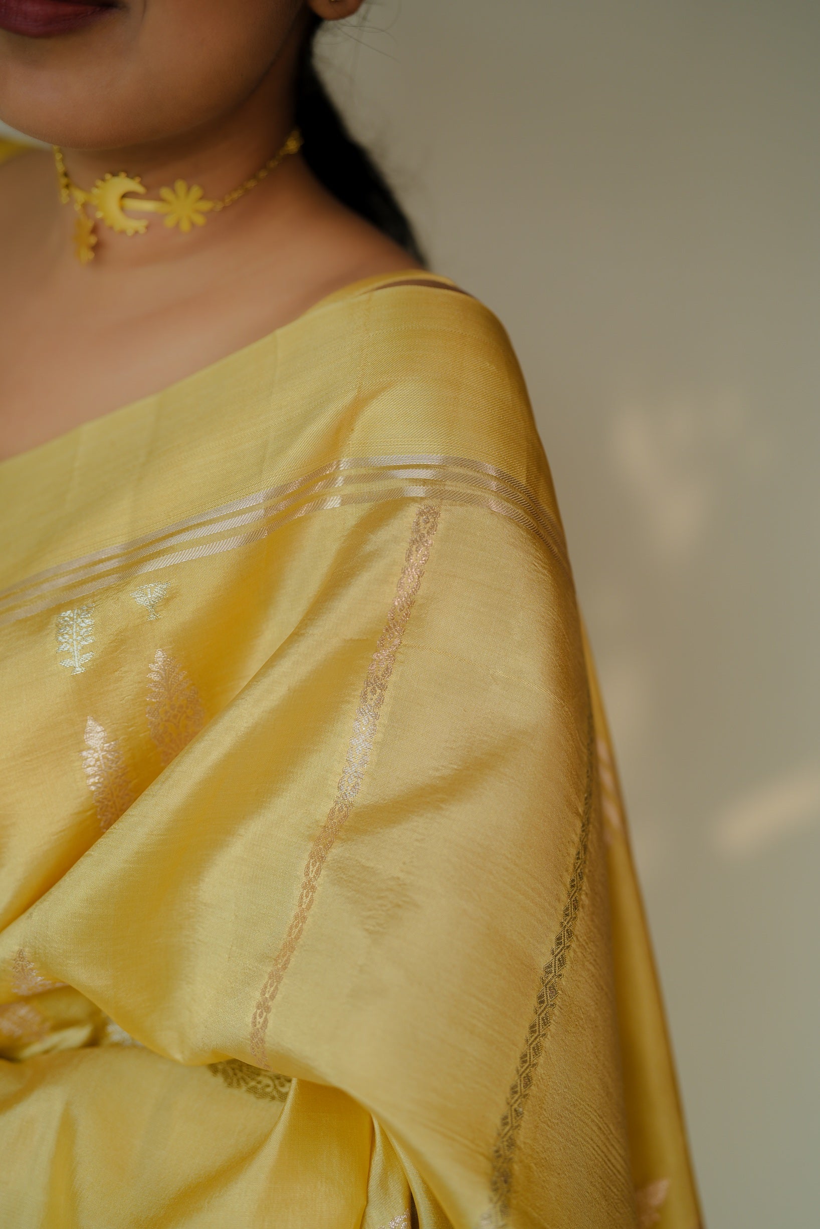 Detailed view of the saree’s shoulder drape, highlighting the sheen and intricate silver zari border.