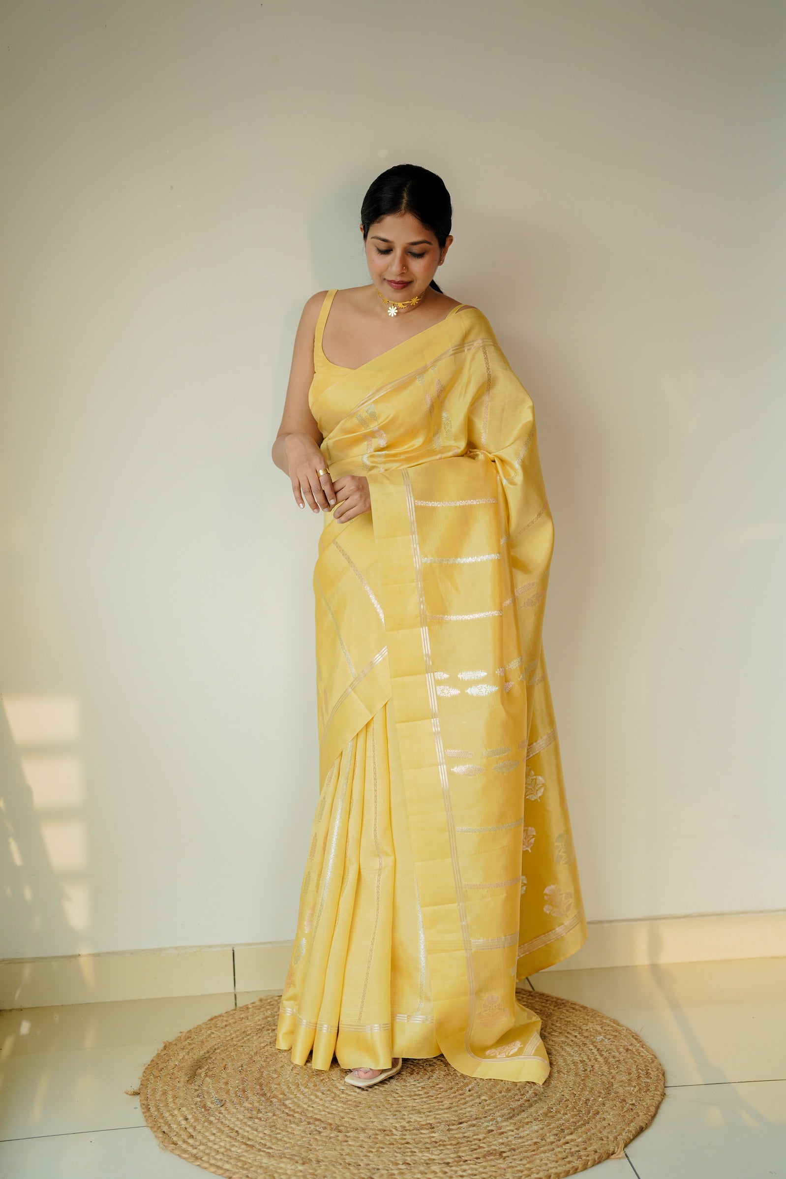 Radiant bride in a mango silk saree with silver detailing, styled for a graceful wedding day or engagement ceremony.