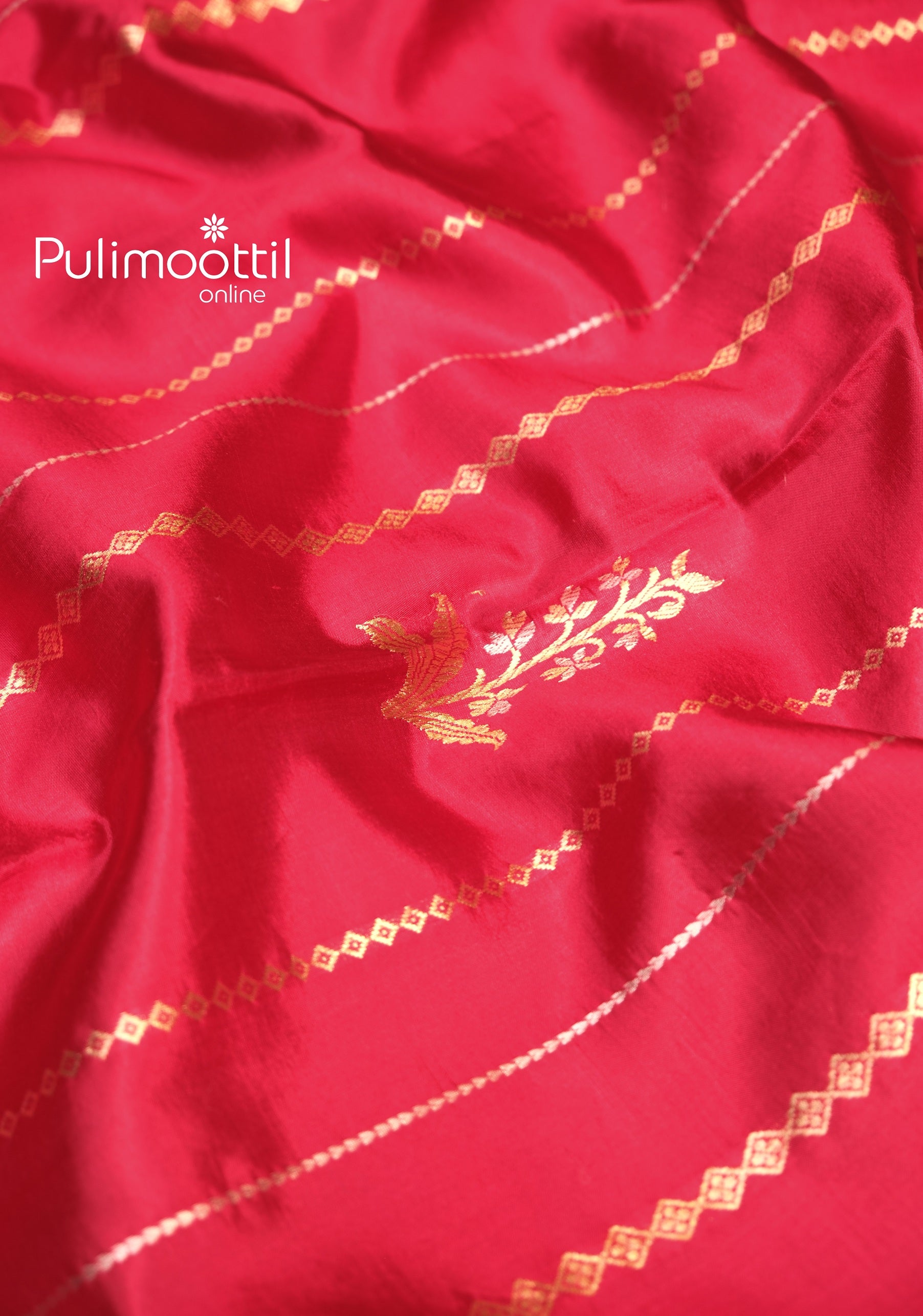 Detailed view of the saree body with golden zari bird and floral motifs set against a rich maroon base, accentuated by diagonal diamond zari lines.