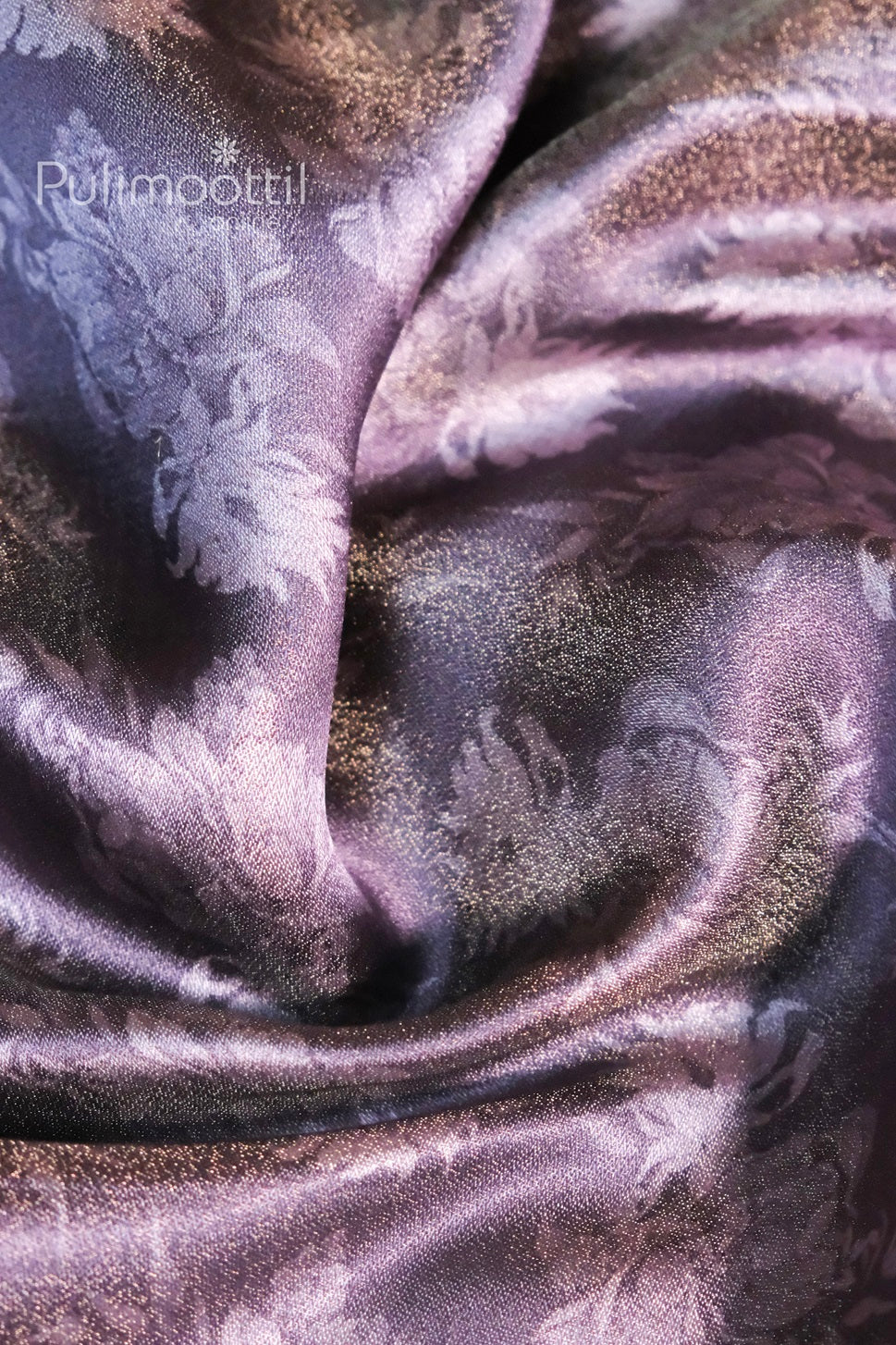 Close-up view of lavender tissue silk saree with a glossy finish and subtle floral digital print, showcasing the soft texture and sheen of the fabric.