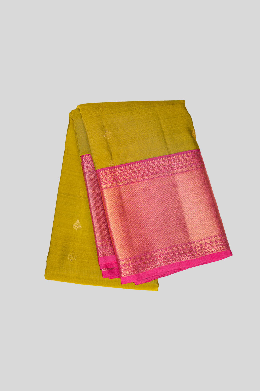 Folded view showing yellow body and pink zari pallu, highlighting the saree’s traditional charm.