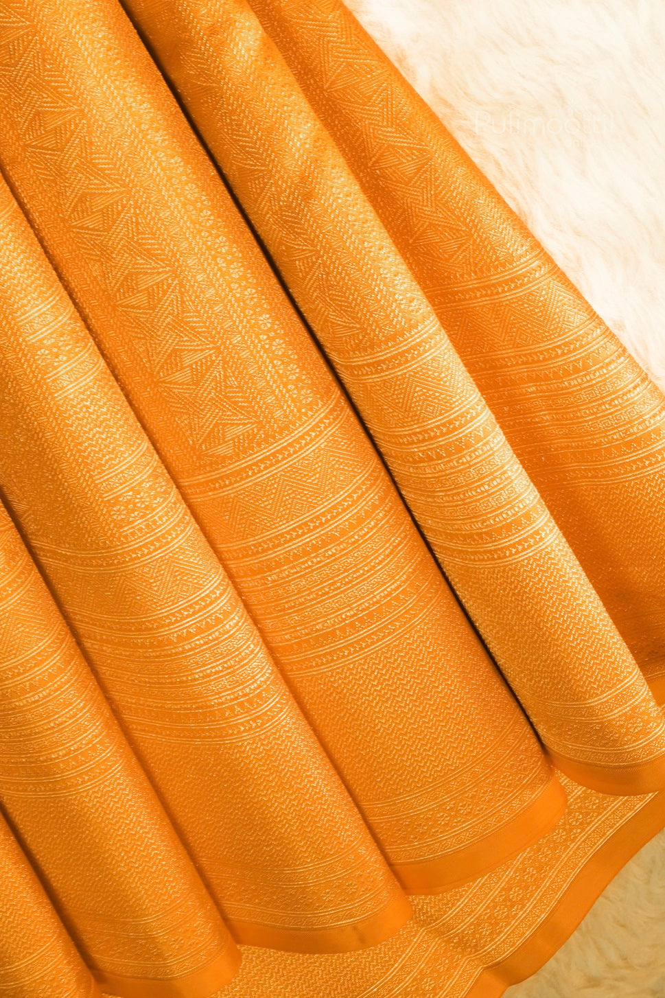 Bridal mustard Kanchipuram saree pleats with intricate zari pallu design