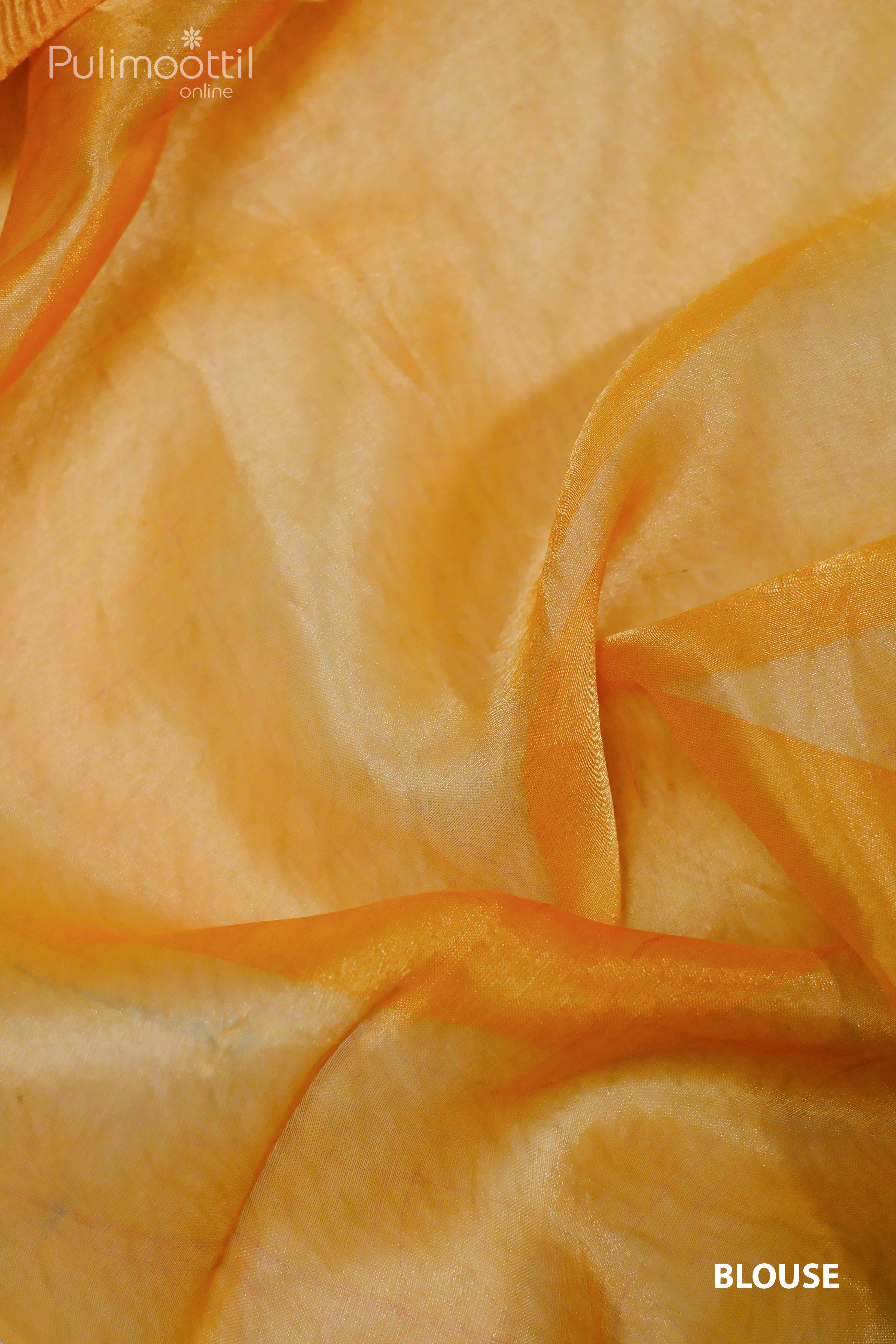 Cllose-up of neon orange crushed tissue fabric, showcasing its texture for blouse design.
