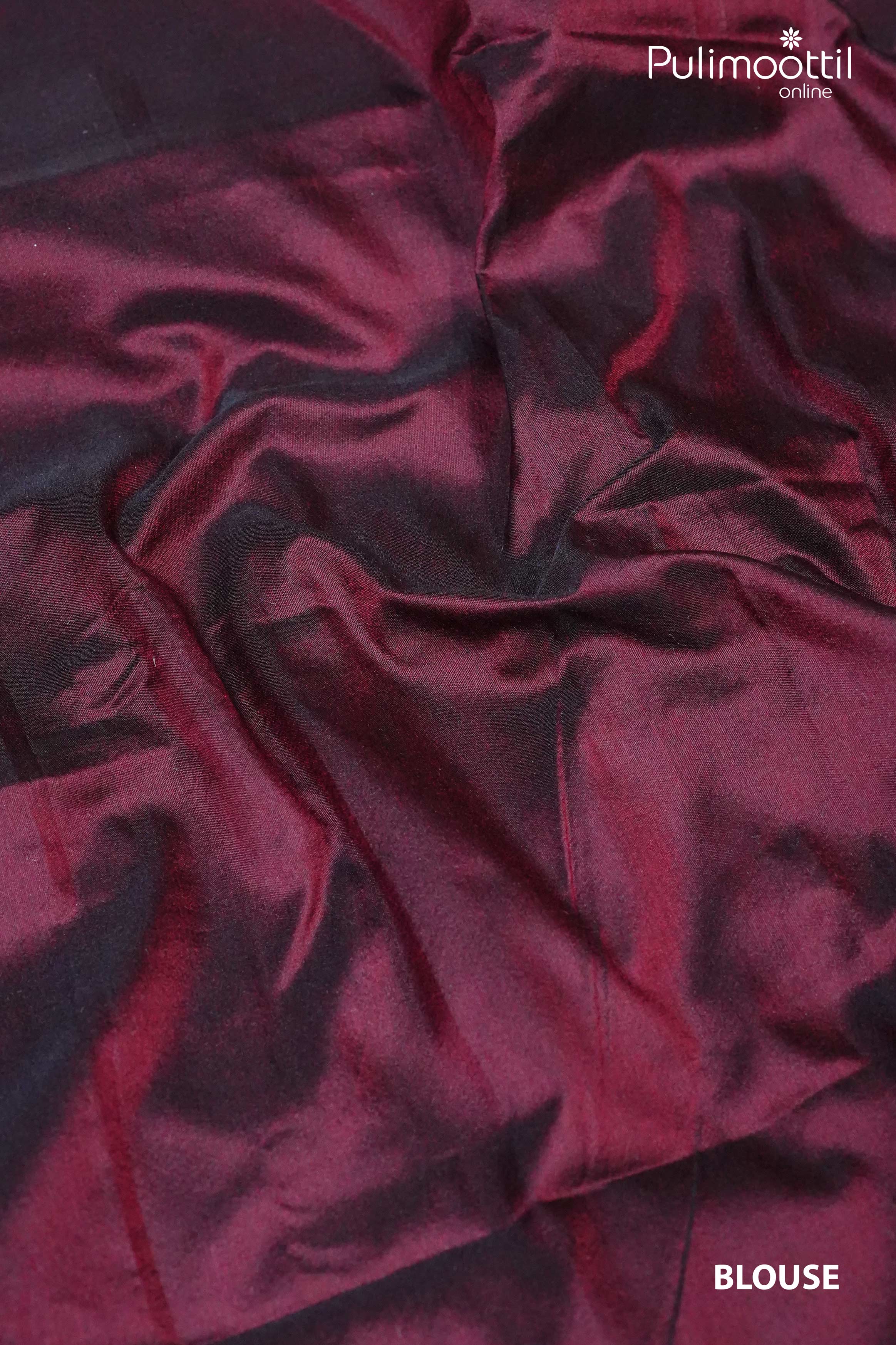 Maroon plain silk blouse fabric with smooth texture and soft sheen, complementing the off-white semi-silk saree.
