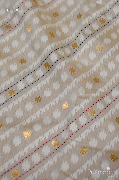 Blouse fabric of off white Chandheri silk saree featuring gold zari buttas with red and blue running stitch embroidery on a geometric pattern background.