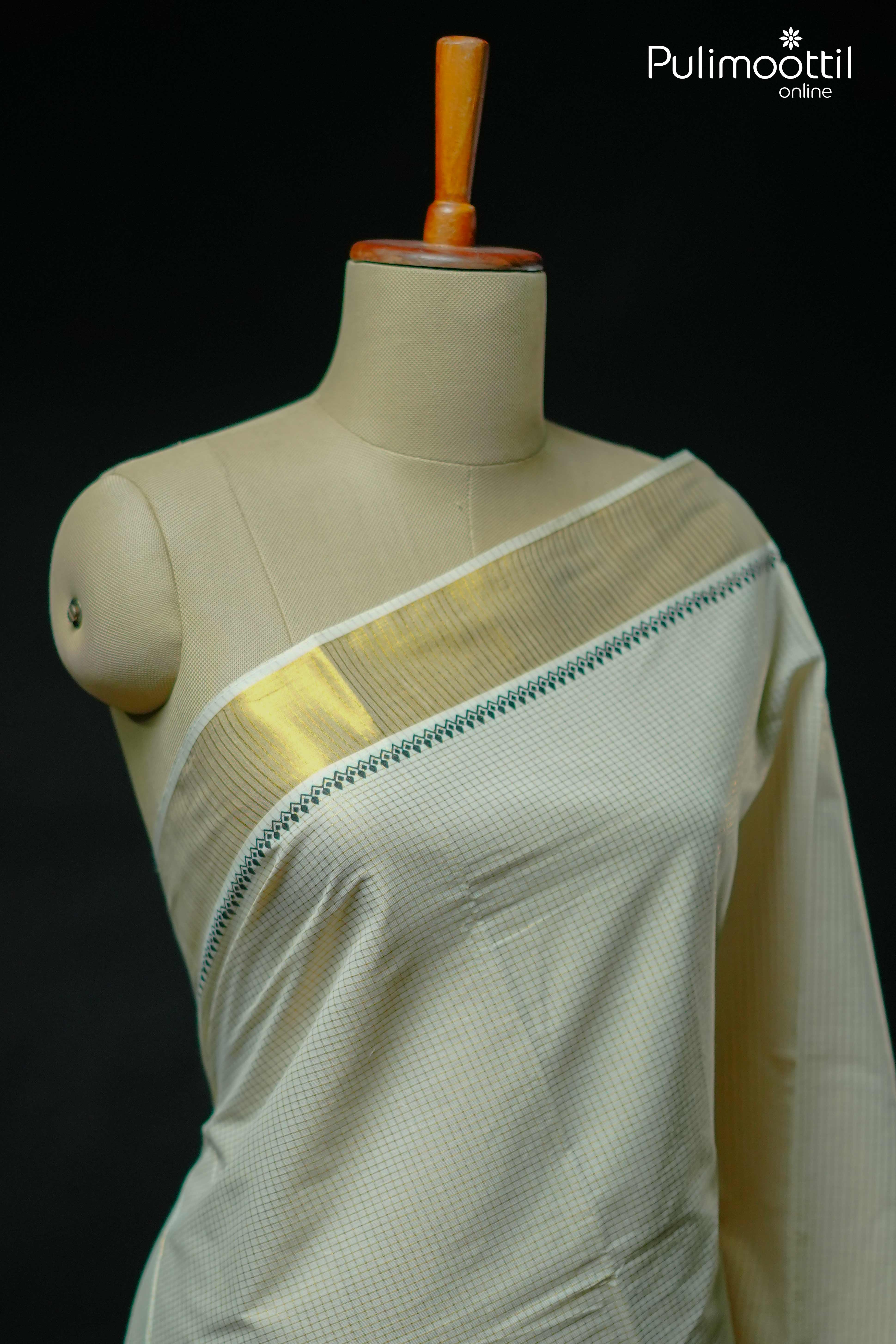 Kerala kasavu saree with golden zari border and black temple design draped on mannequin
