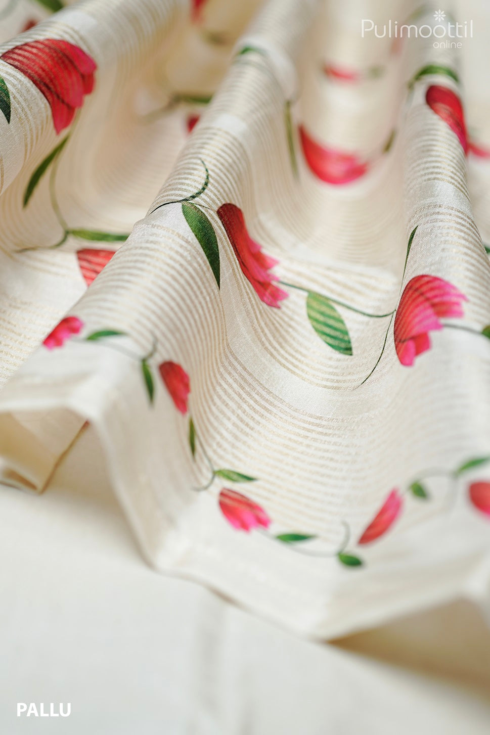 Off white semi tissue silk saree pallu with golden zari stripes and red floral prints with green leaves, elegant drape detail.