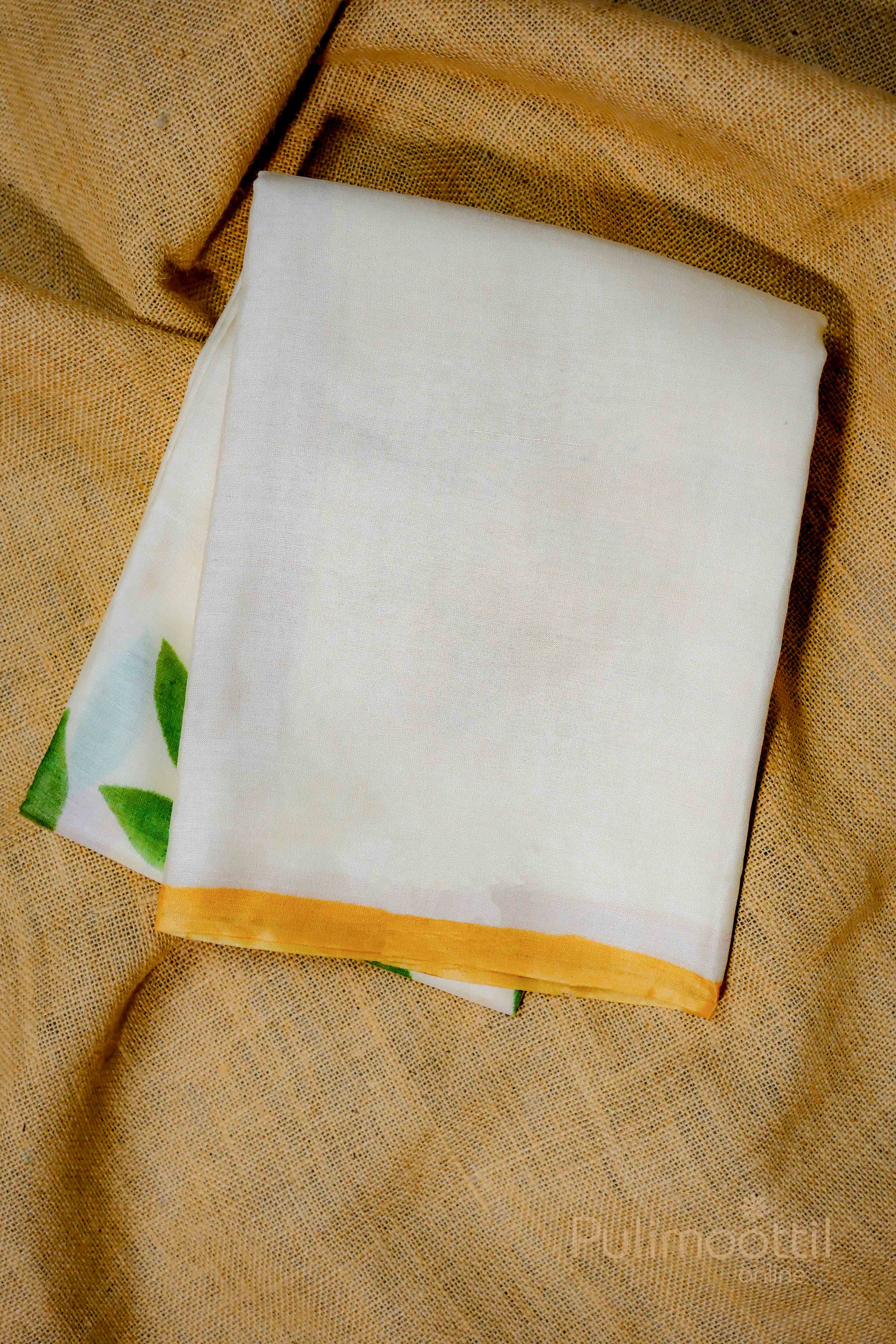 Folded Off-white Tassar saree with floral design and orange border, showcasing the fabric details.
