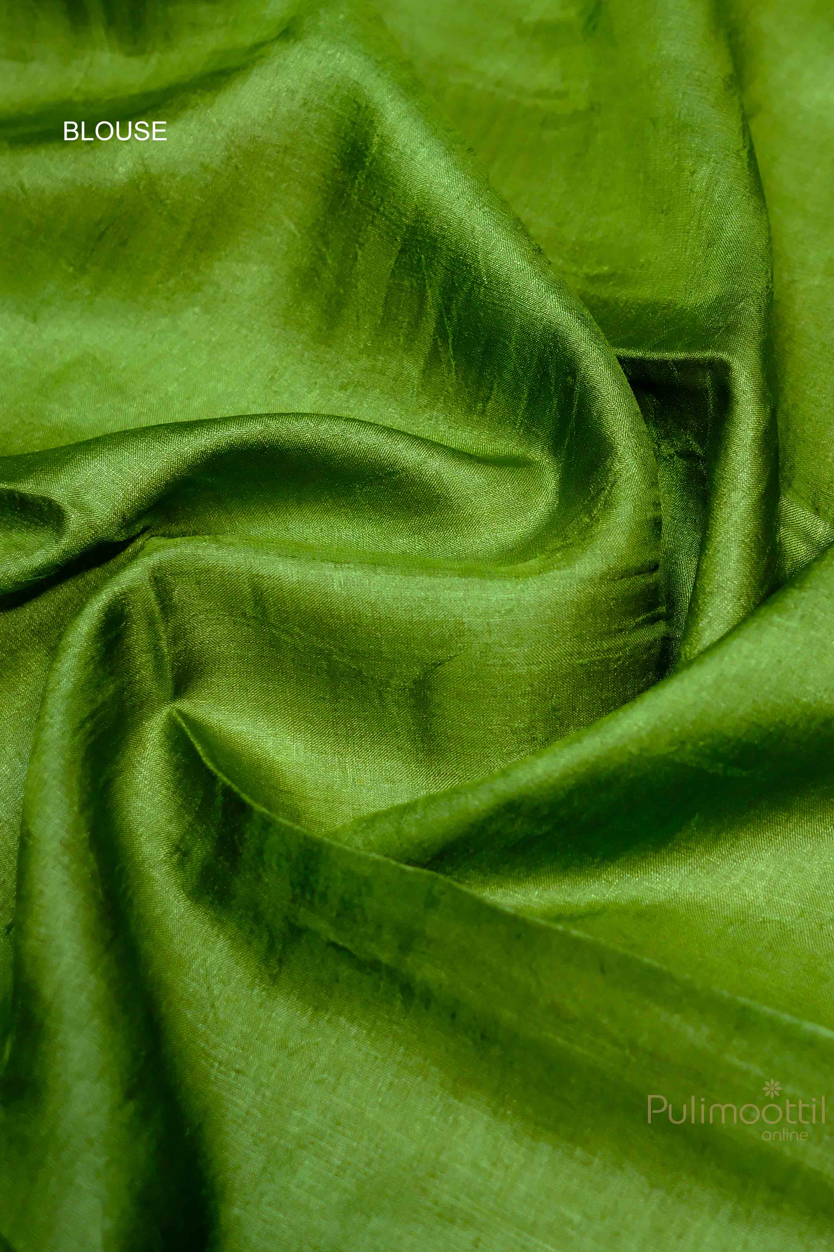 "Green blouse fabric with a smooth finish, perfectly matching the contrast green border of the off-white Tassar saree.