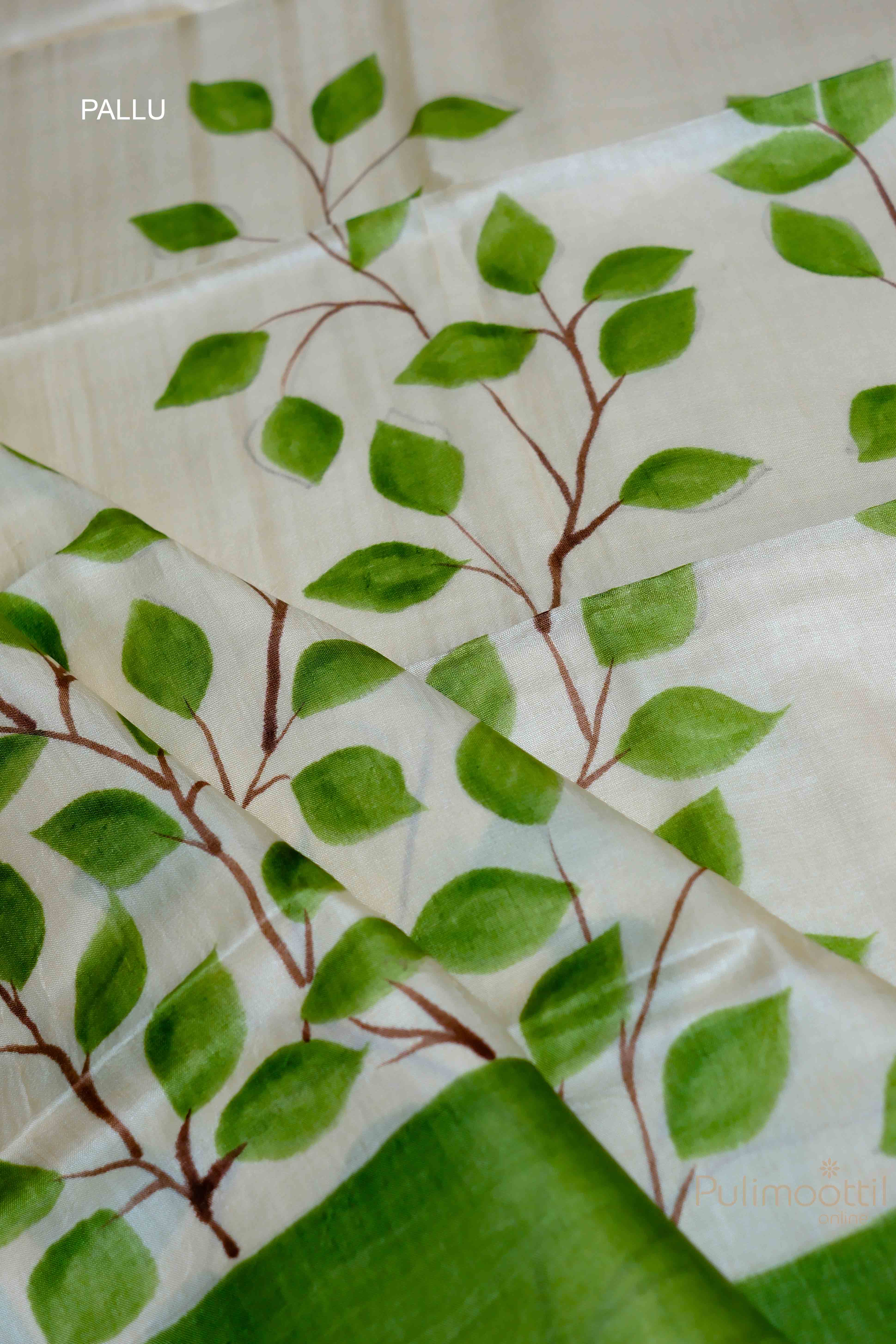 Detailed view of the pallu of the off-white Tassar Onam saree, featuring a floral design and green contrast border.