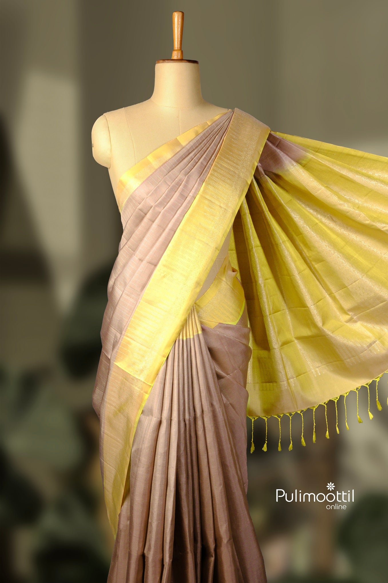 Oyster gray Kanchipuram saree with contrasting yellow pallu displayed on a mannequin