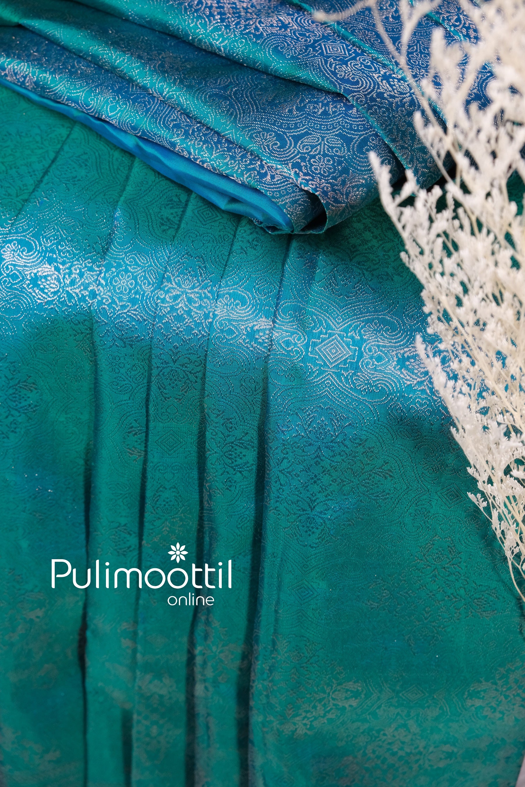 Draped peacock green Kanchipuram silk saree featuring silver zari pallu and tassels, perfect for brides who prefer heritage and timeless elegance.