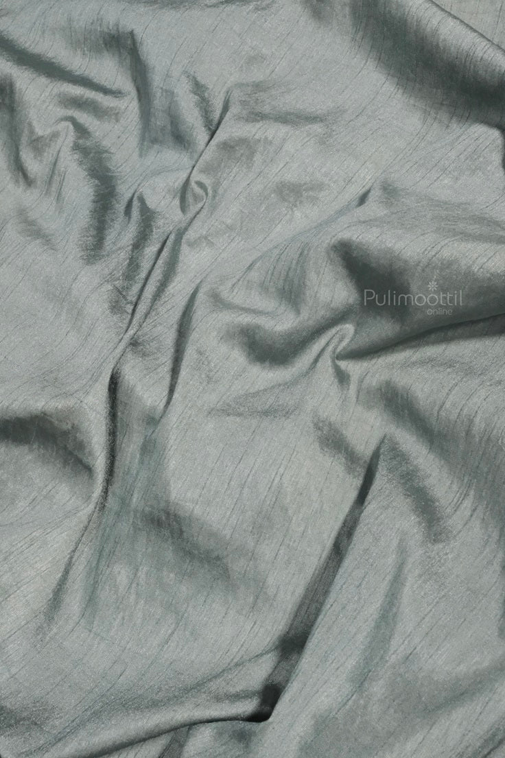 Pastel green blouse piece of crushed organza saree displayed with a smooth texture and soft sheen.