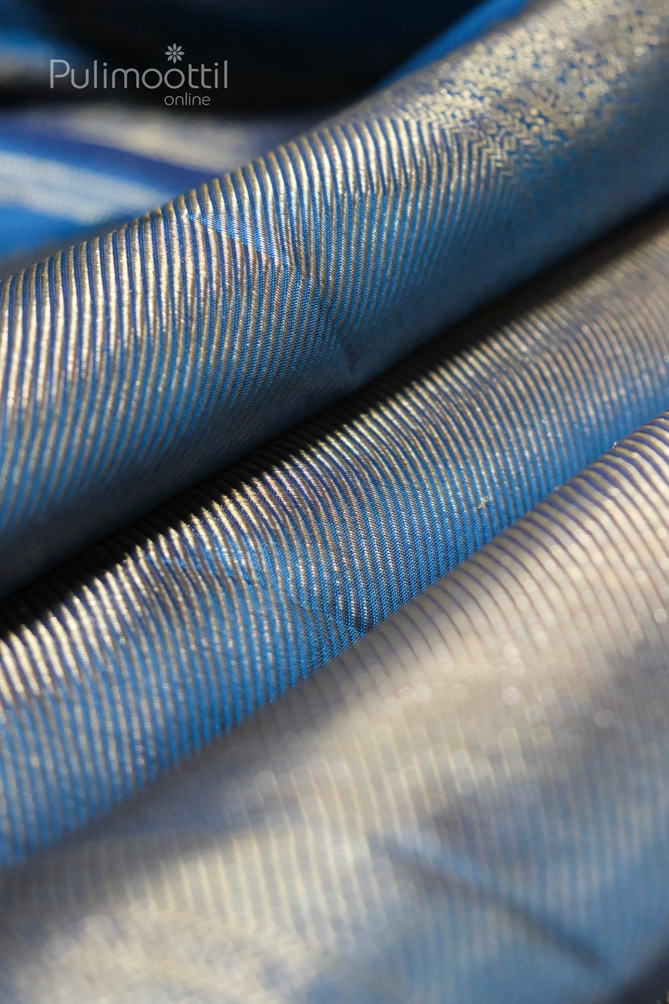 Close-up of blue Banarasi silk saree with intricate golden zari butti weave—luxurious party wear saree ideal for bridal, festive, or wedding occasions.