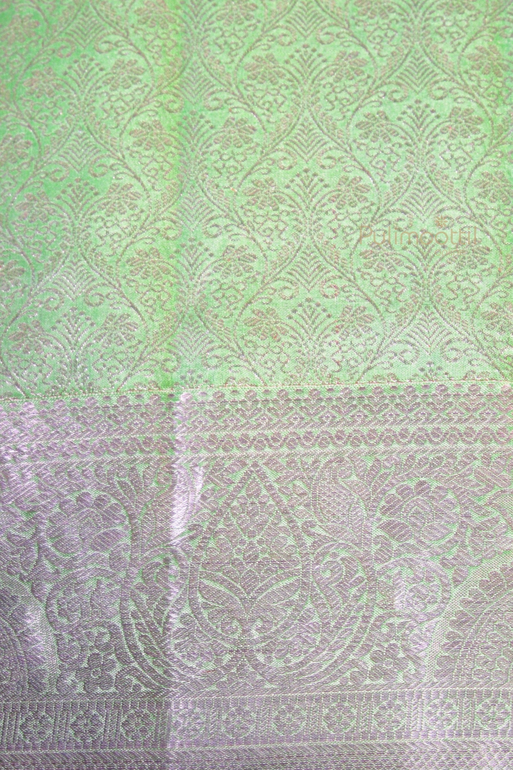 Intricate silver zari pattern on pista green Kanchipuram silk saree pallu and border detail