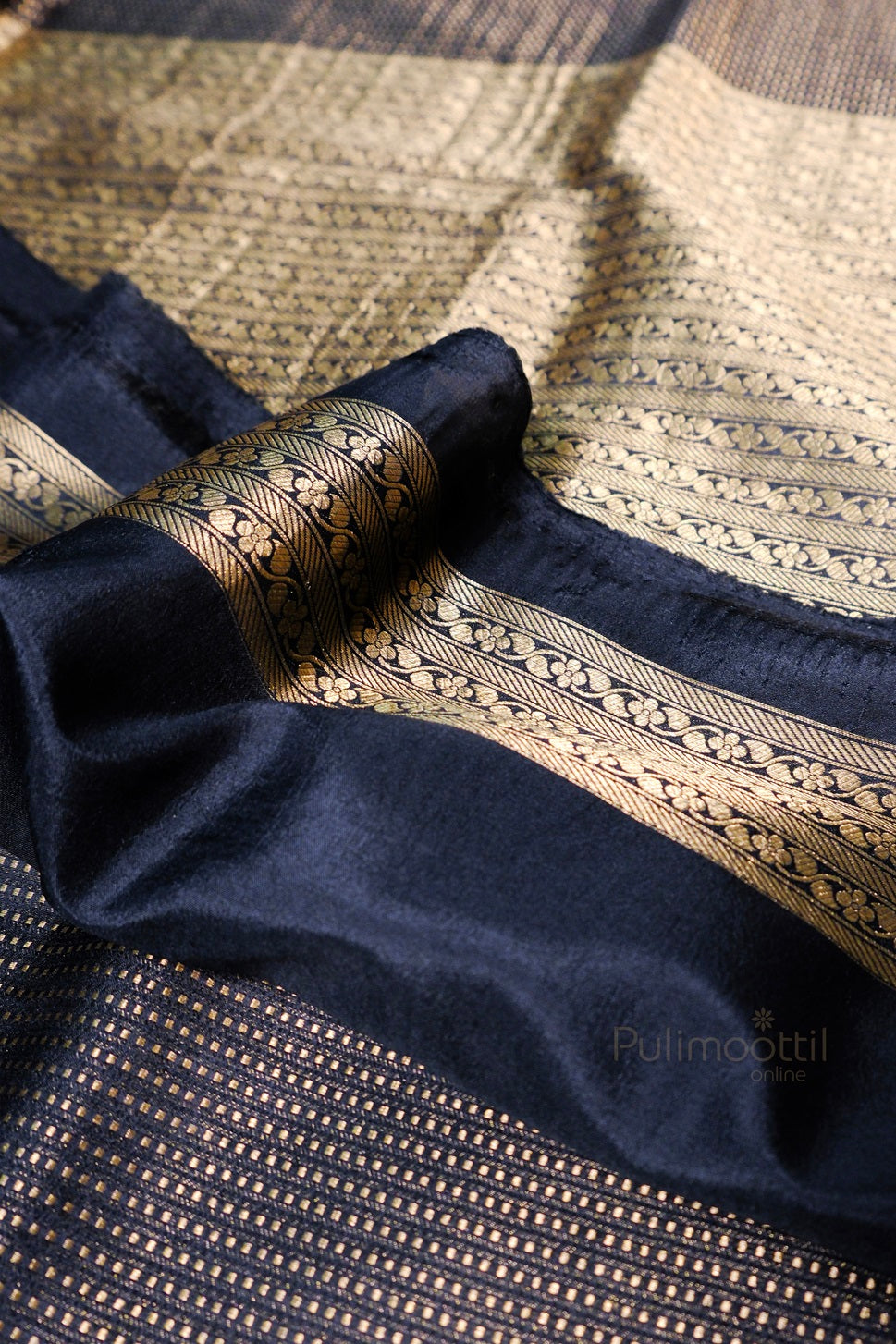 Luxurious gold brocade textile showing detailed craftsmanship with paisley patterns and diagonal stripe design