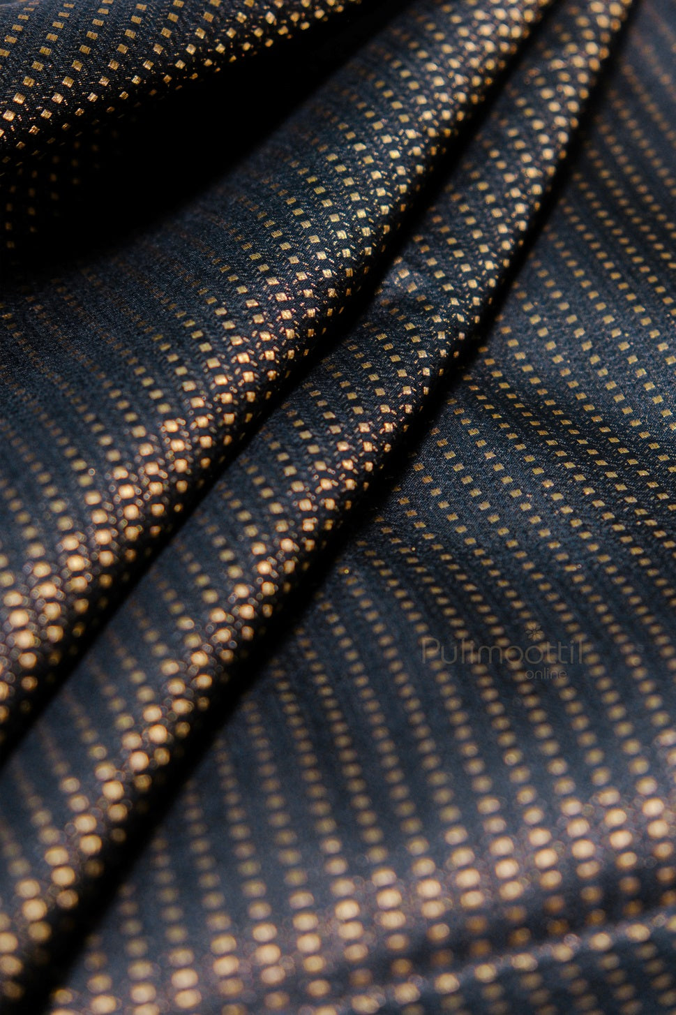 Rich navy blue silk fabric with small gold polka dot pattern creating elegant textured surface