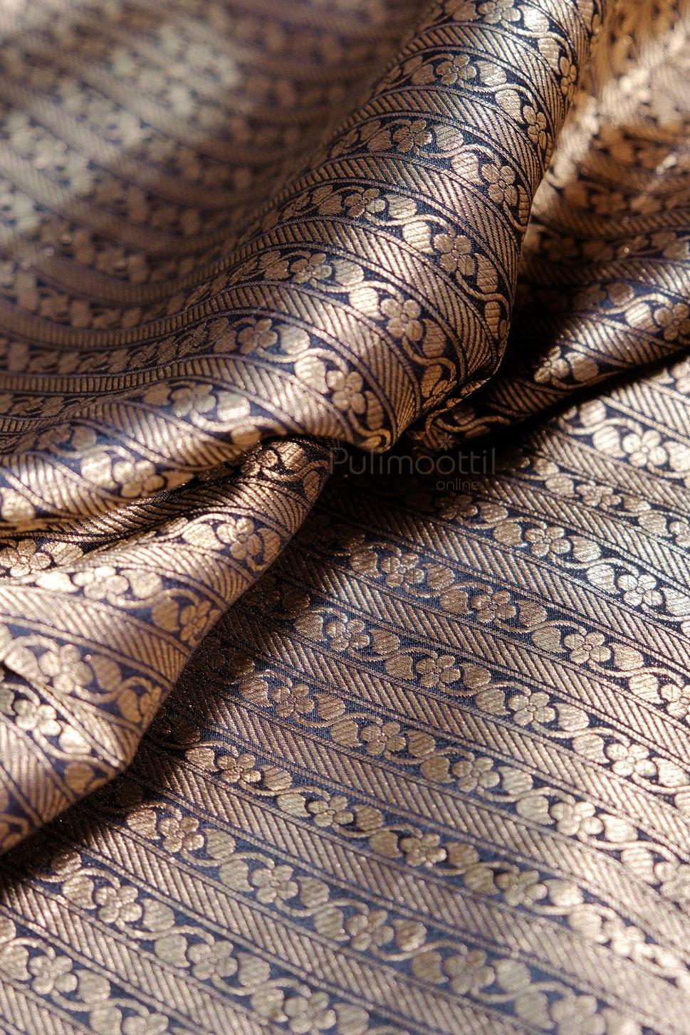 Premium navy blue silk saree with golden border displaying traditional Indian textile artistry and fine weaving details