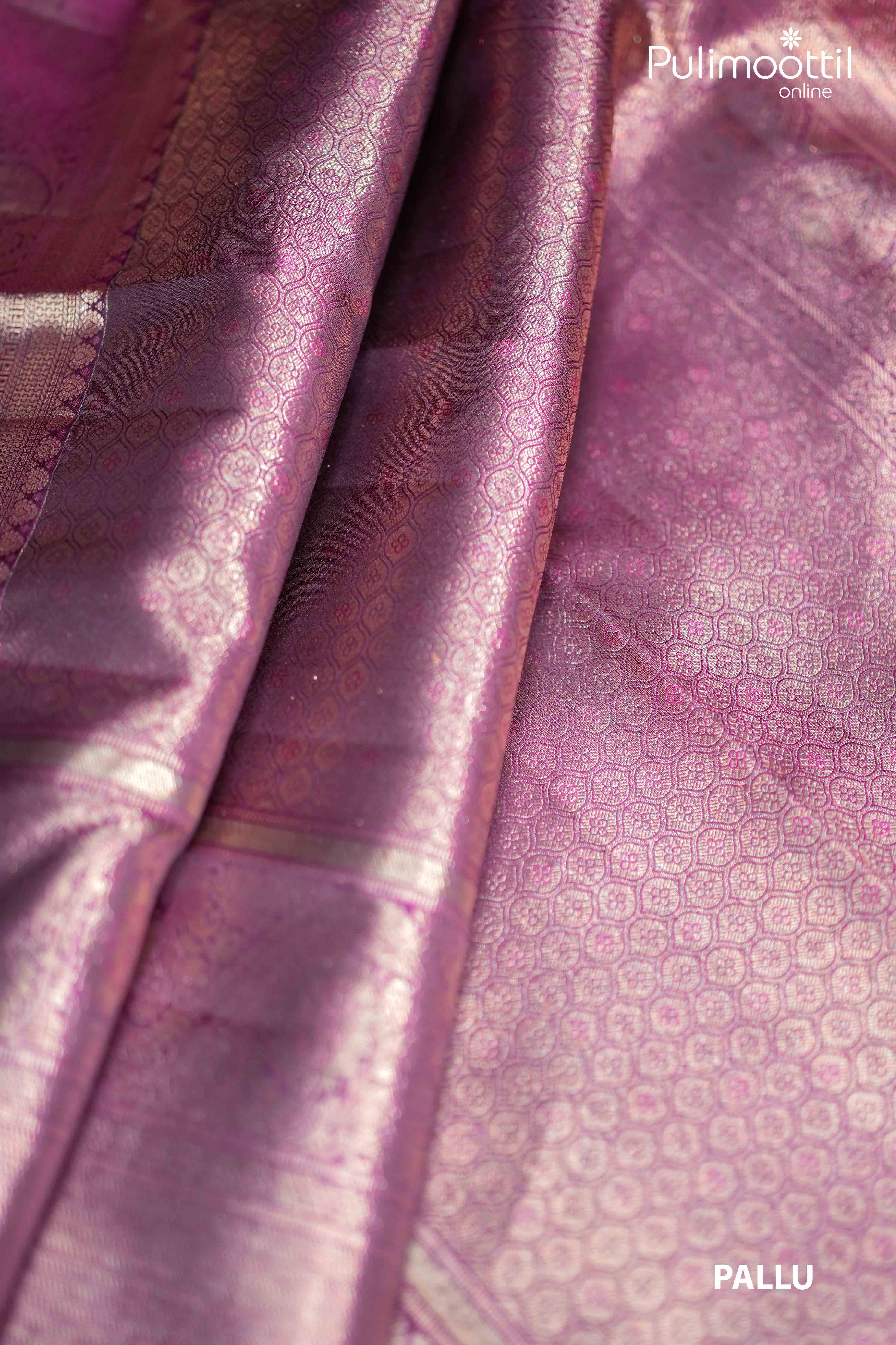 Close-up of purplle plum Kanchipuram saree pallu featuring fine copper zari weaving in traditional geometric motifs, showcasing opulence and ideal for festive occasions like Onam and weddings.