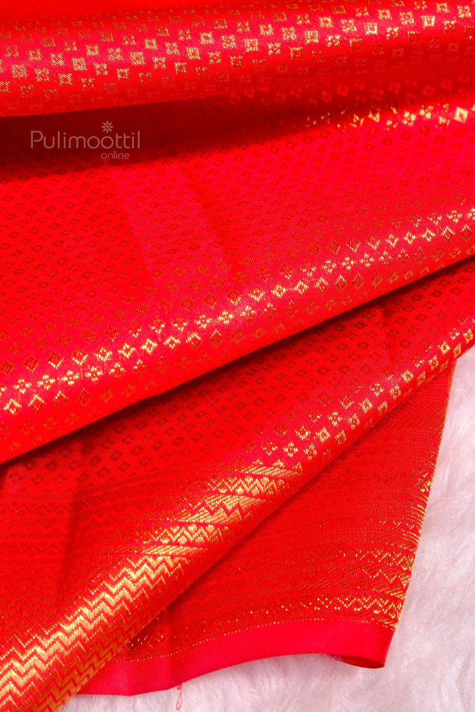 Pallu of mustard bridal saree with traditional gold zari motifs and border