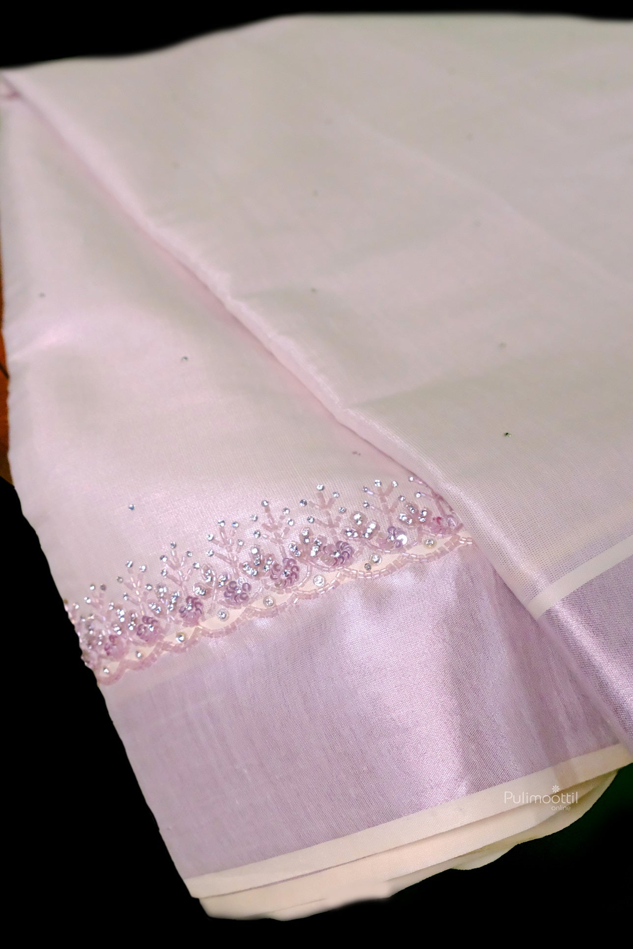 Elegant Kerala tissue saree in rose gold shade featuring delicate handcrafted border design