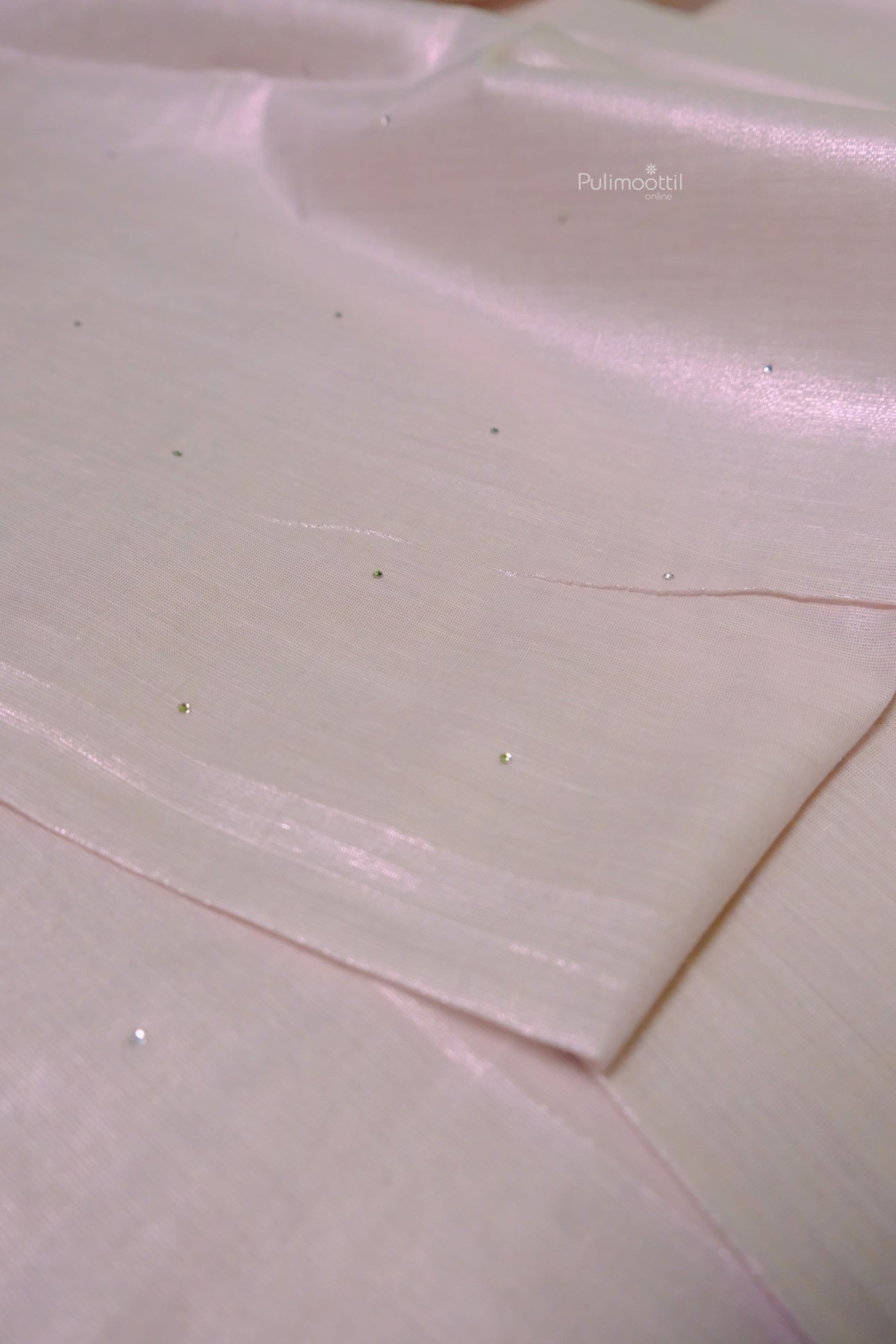 Minimalist rose gold tissue Kerala saree with subtle scattered bead embellishments