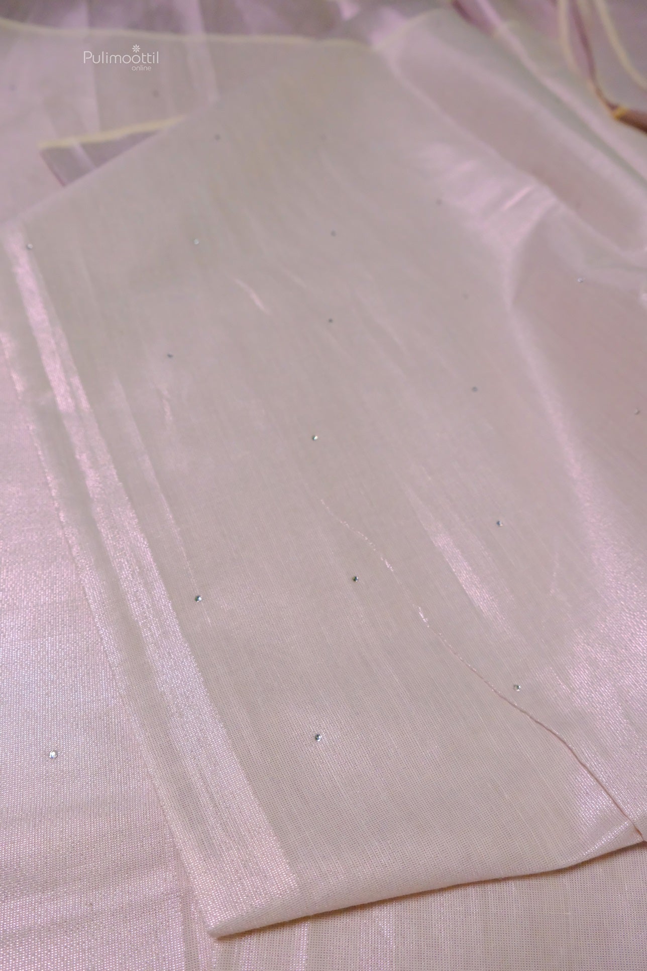 Minimalist rose gold tissue Kerala saree with subtle scattered bead embellishments