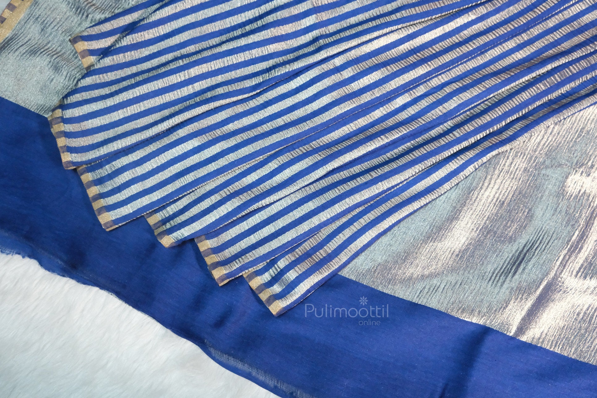 Blue and silver striped crinkled silk saree with solid royal blue border, draped and layered, Pulimoottil Online branded fabric.