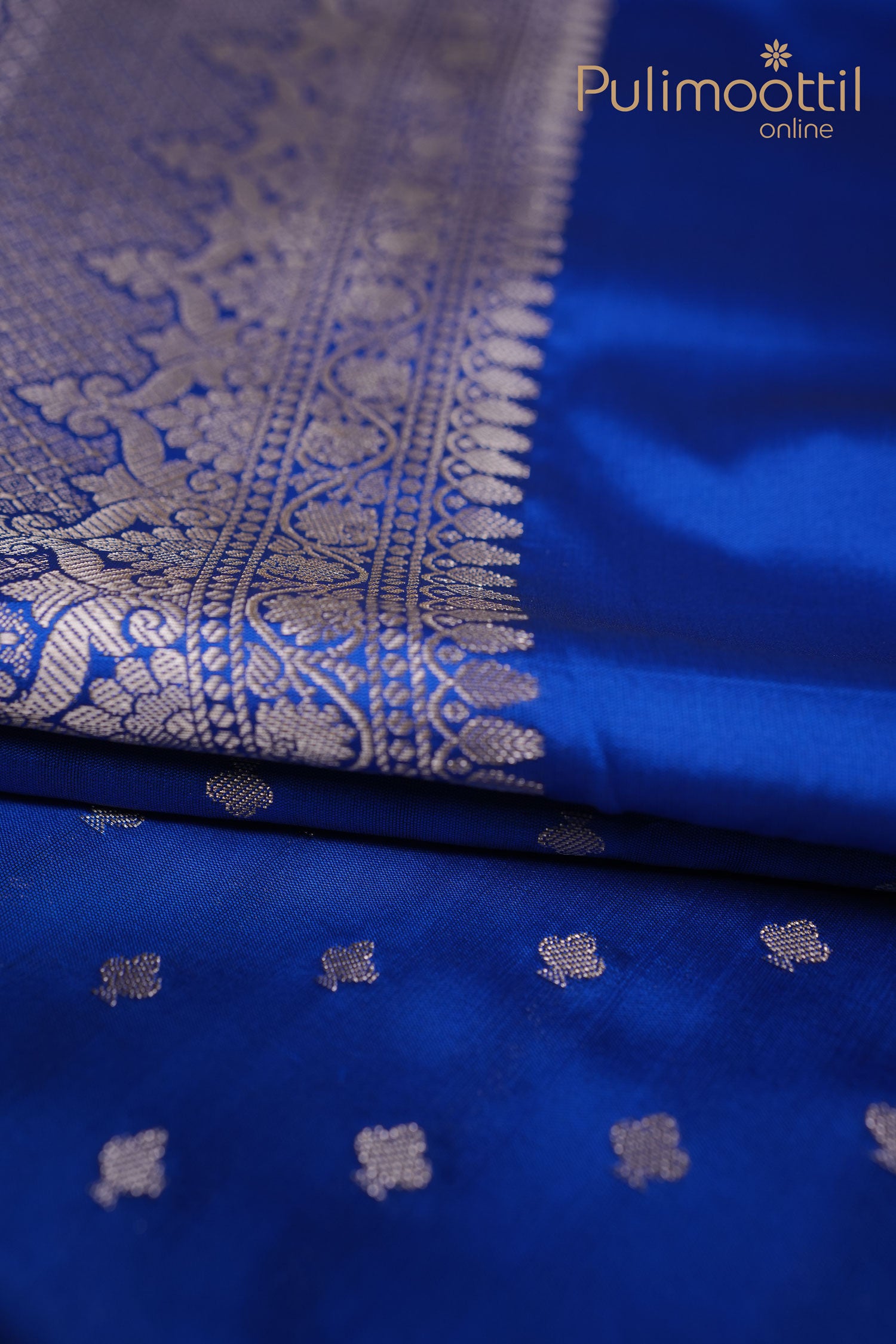 Royal blue semi silk saree with intricate silver zari butta work on the pallu.