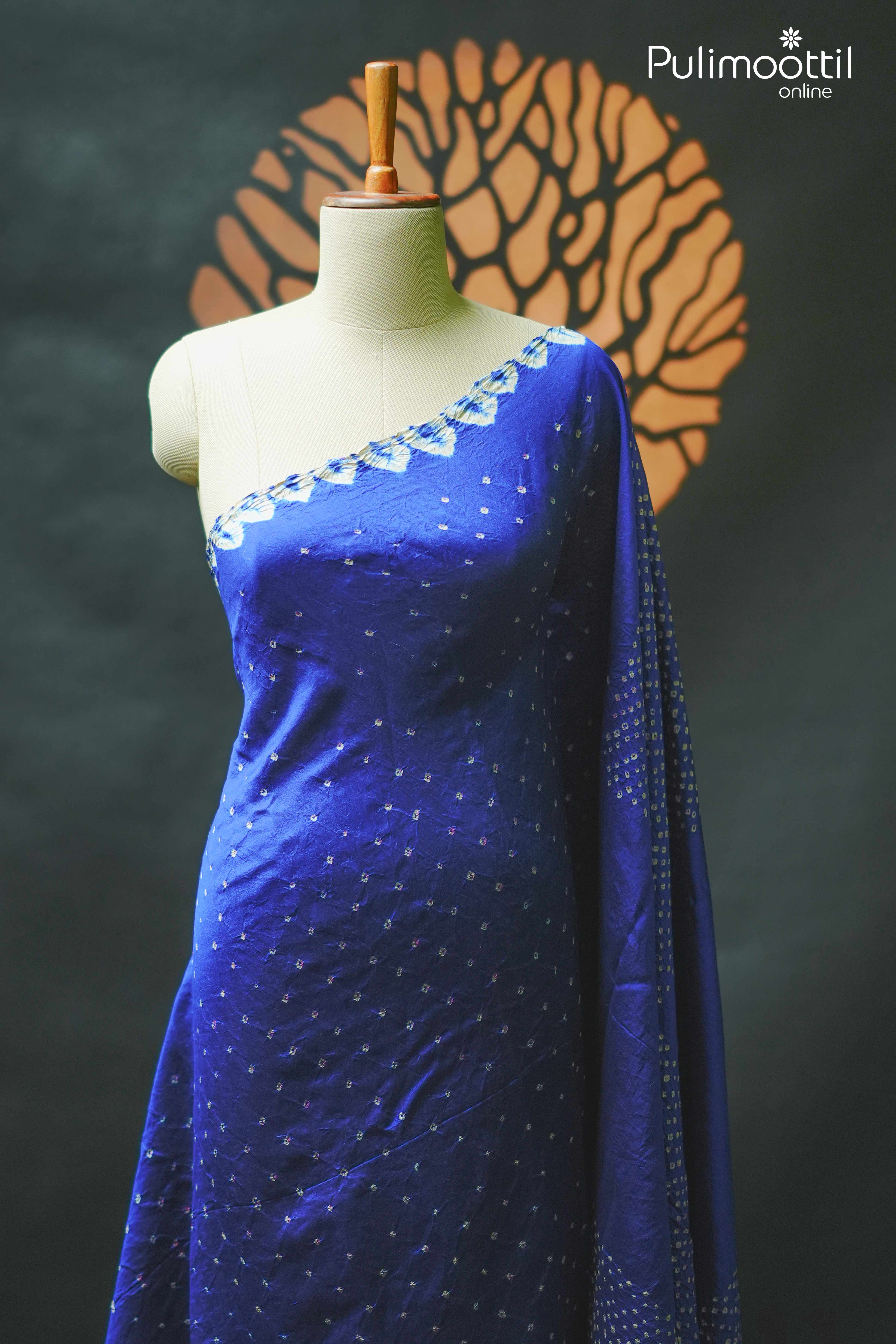Royal blue Tussar silk Chungidi saree draped on a mannequin, featuring delicate tie and dye patterns and a subtle border.