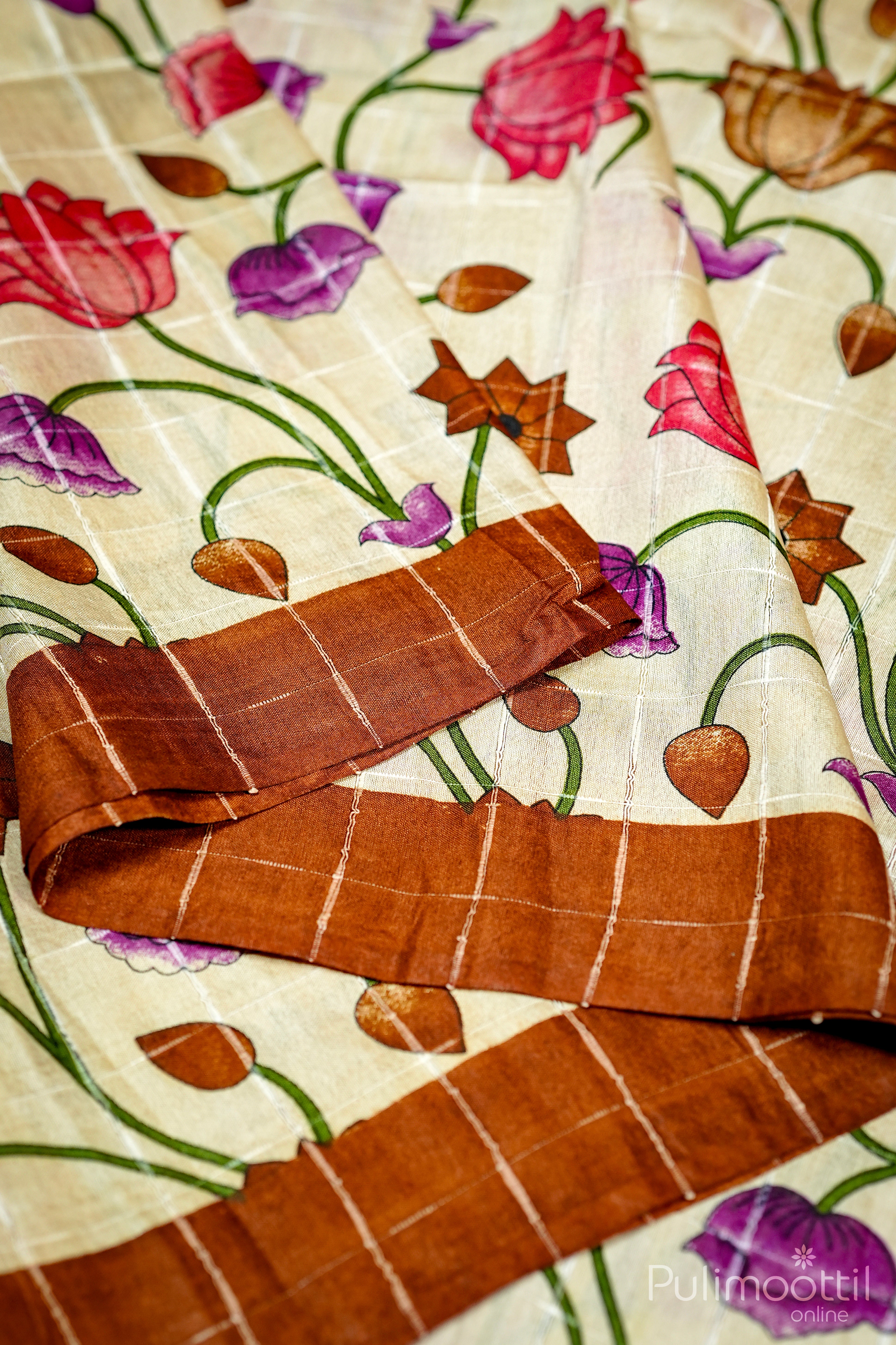 Semi Tussar saree with cream base, multicolor floral printed body, and brown checked border – Pulimoottil Silks
