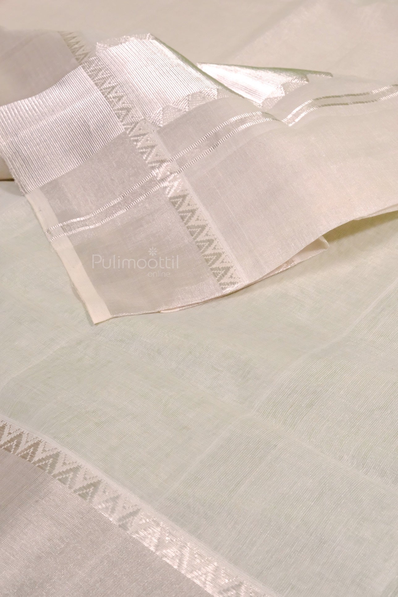 Detailed view of pure cotton handloom Kerala saree blouse piece with silver border and soft texture and fine weave