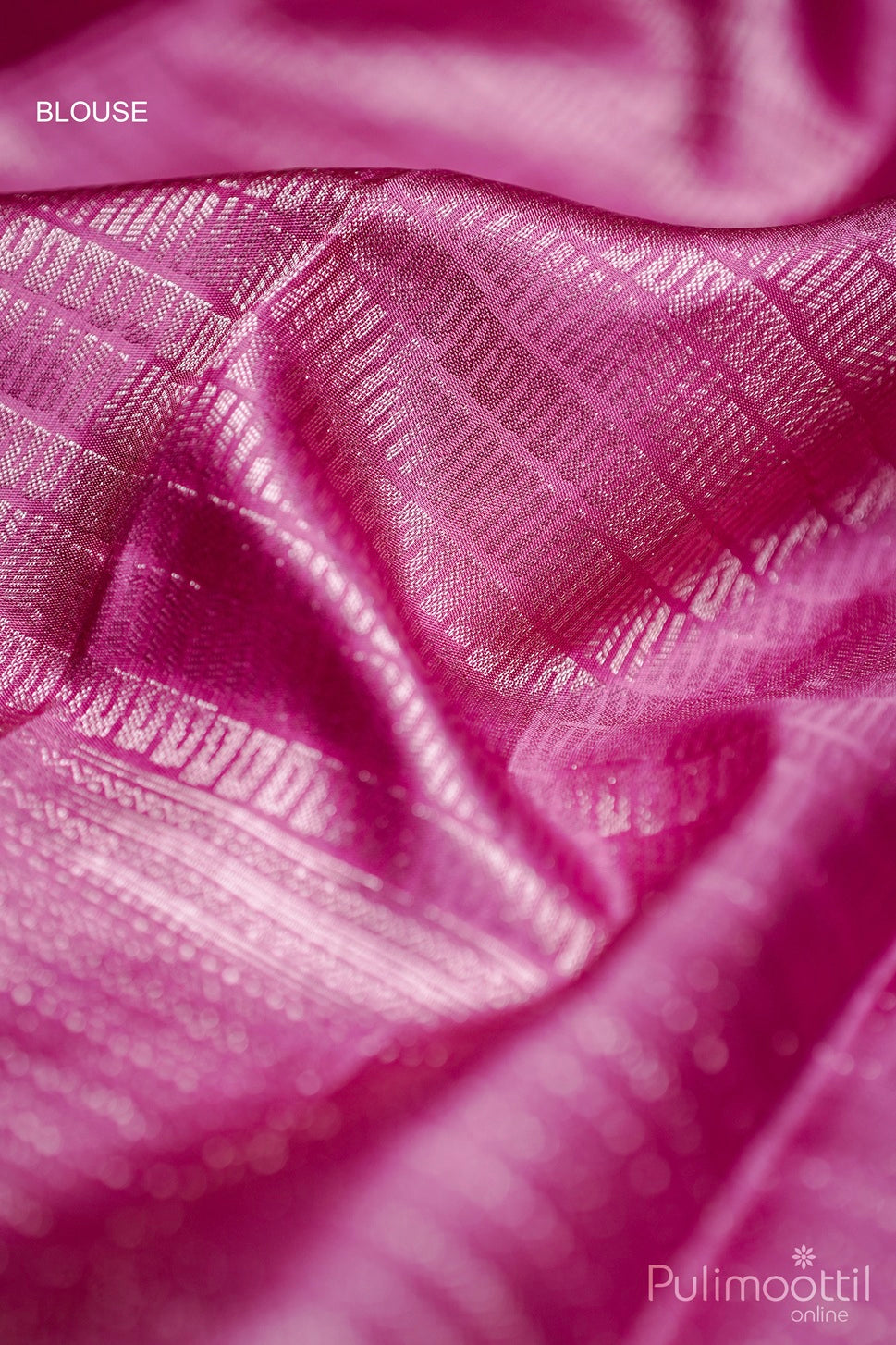 Soft-pink Kanchipuram silk blouse detail featuring gold zari geometric weave.