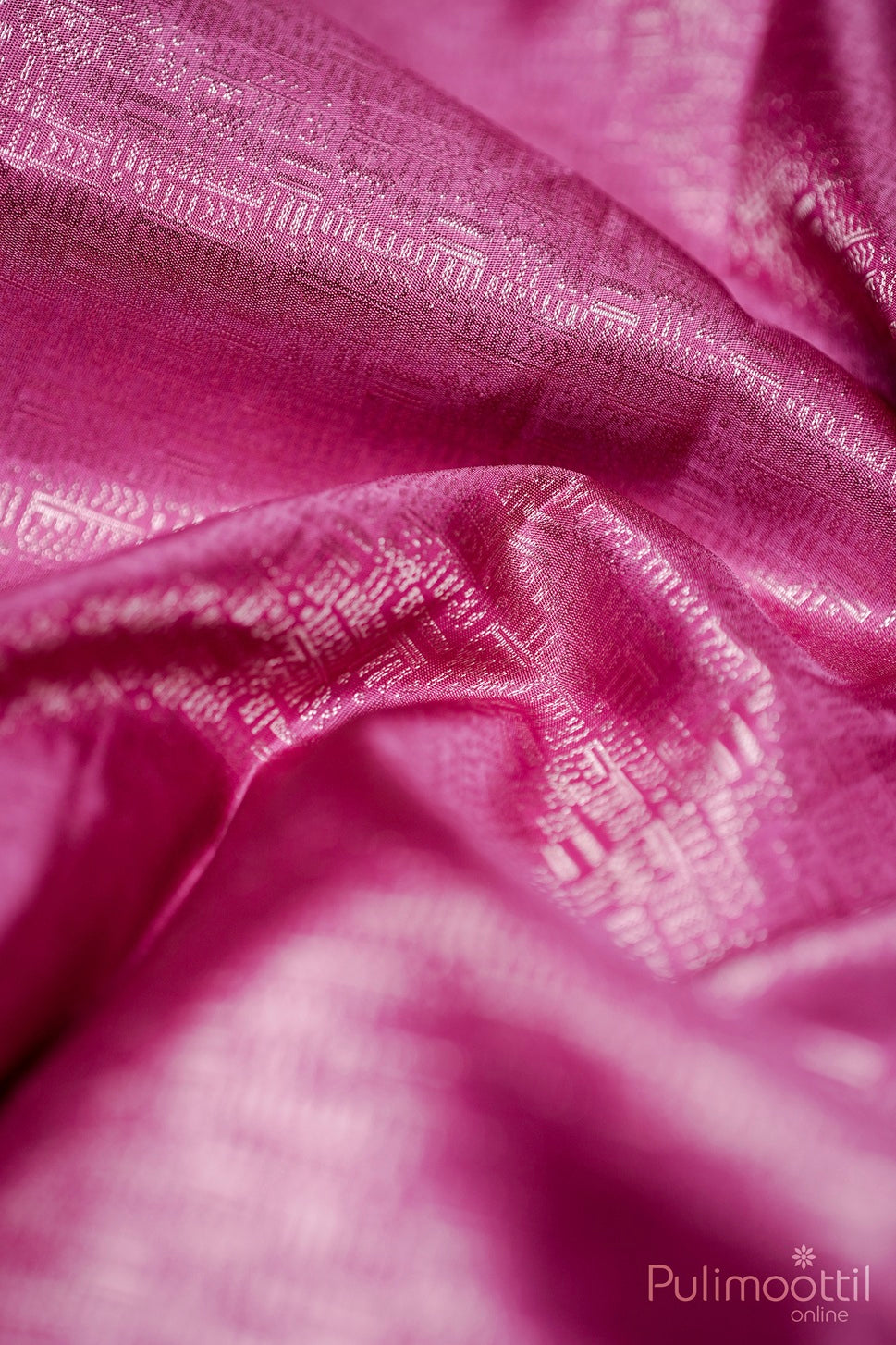 Silky soft-pink blouse cloth showcasing fine gold zari geometric brocade weave.