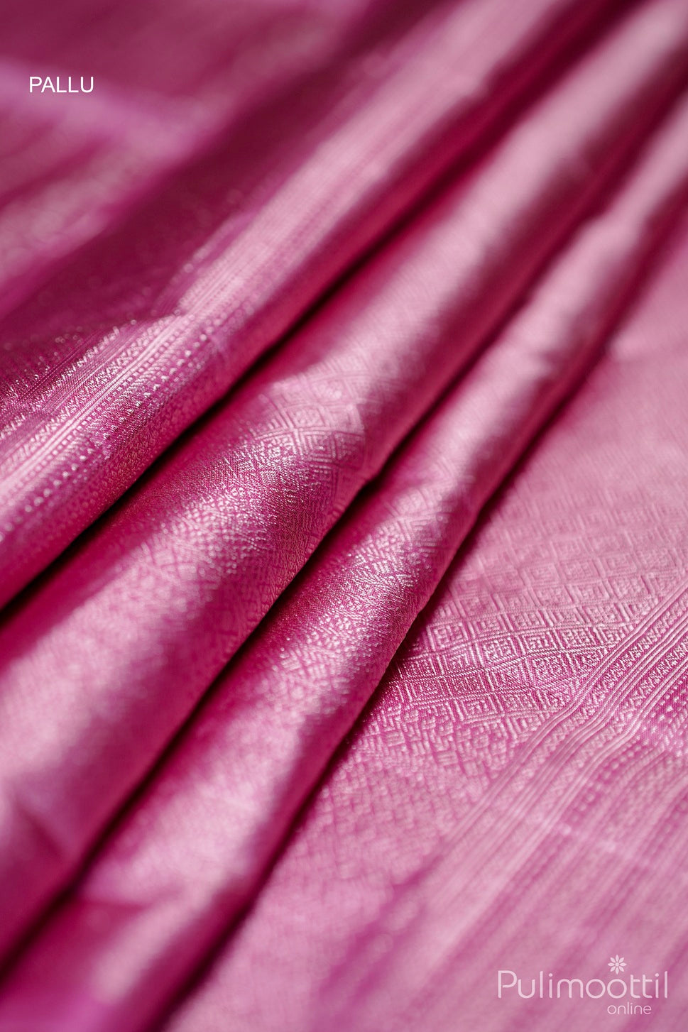 Soft pink saree pallu with gold-brocade geometric weave.