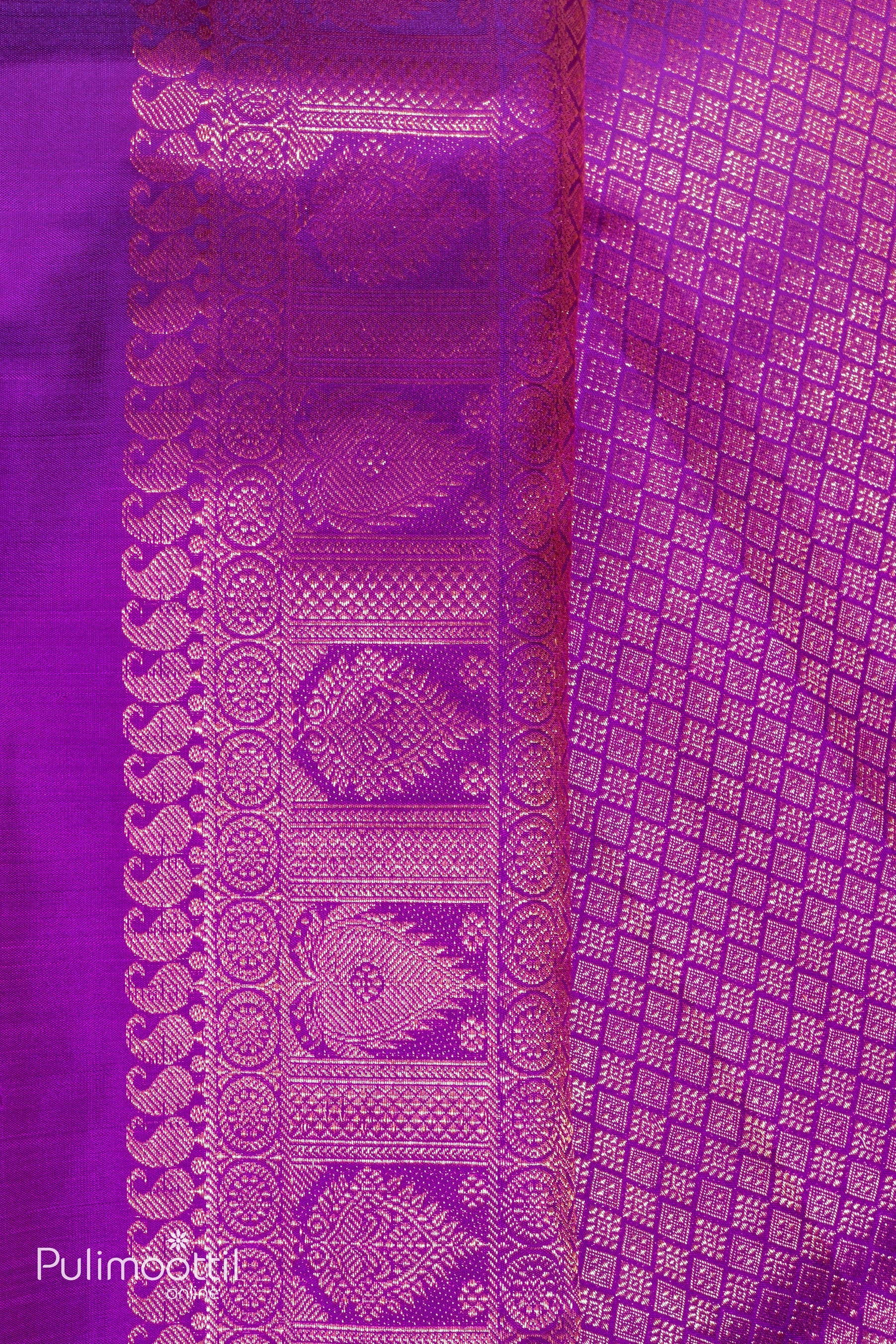 Detailed view of the pallu and border of a violet Kanchipuram saree featuring rich golden motifs and traditional patterns.