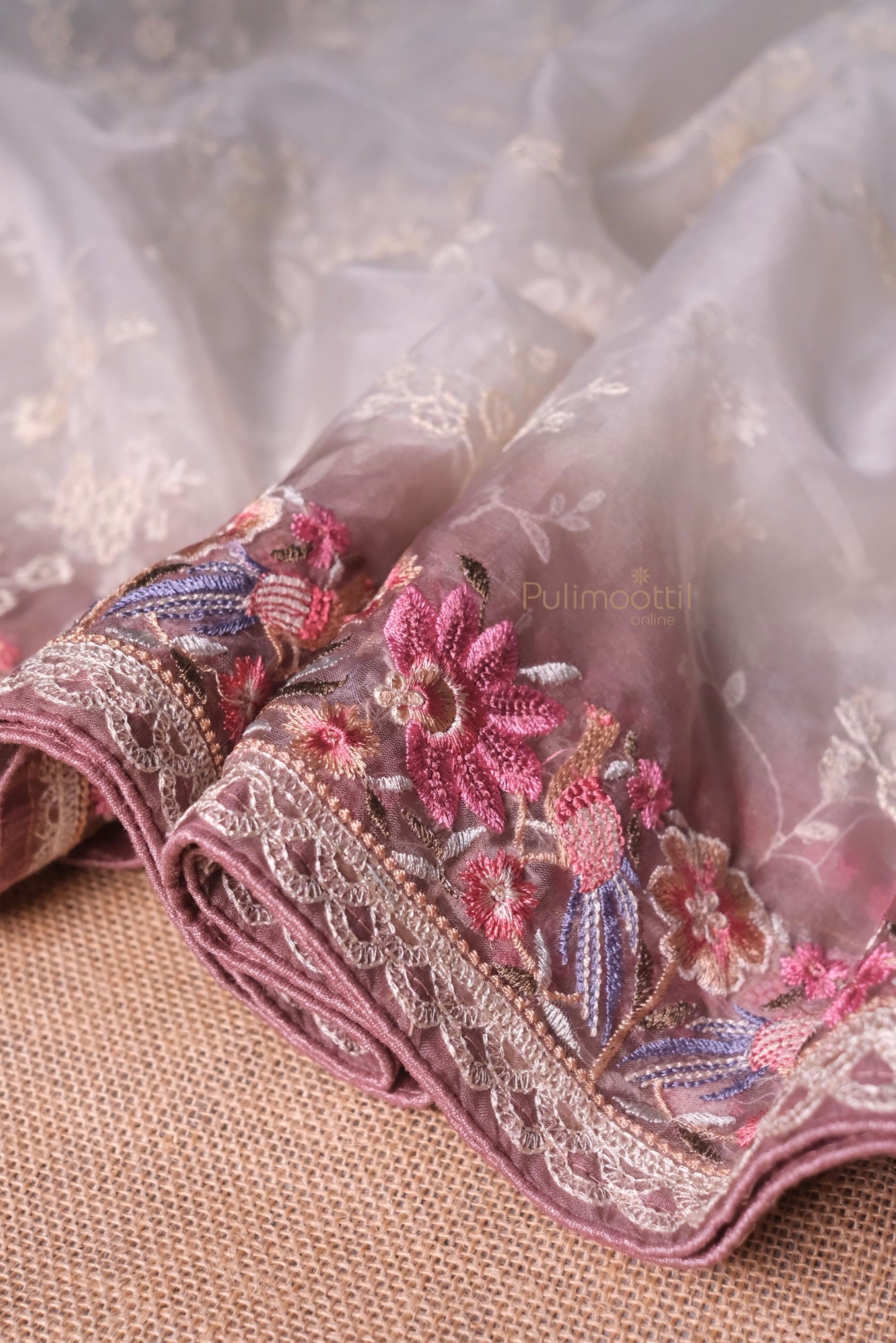 This close-up highlights the fine craftsmanship — intricate threadwork and subtle sequin shimmer dancing across the fabric. The organza glows under natural light, enhancing the soft white palette. Zoom in to fall in love.