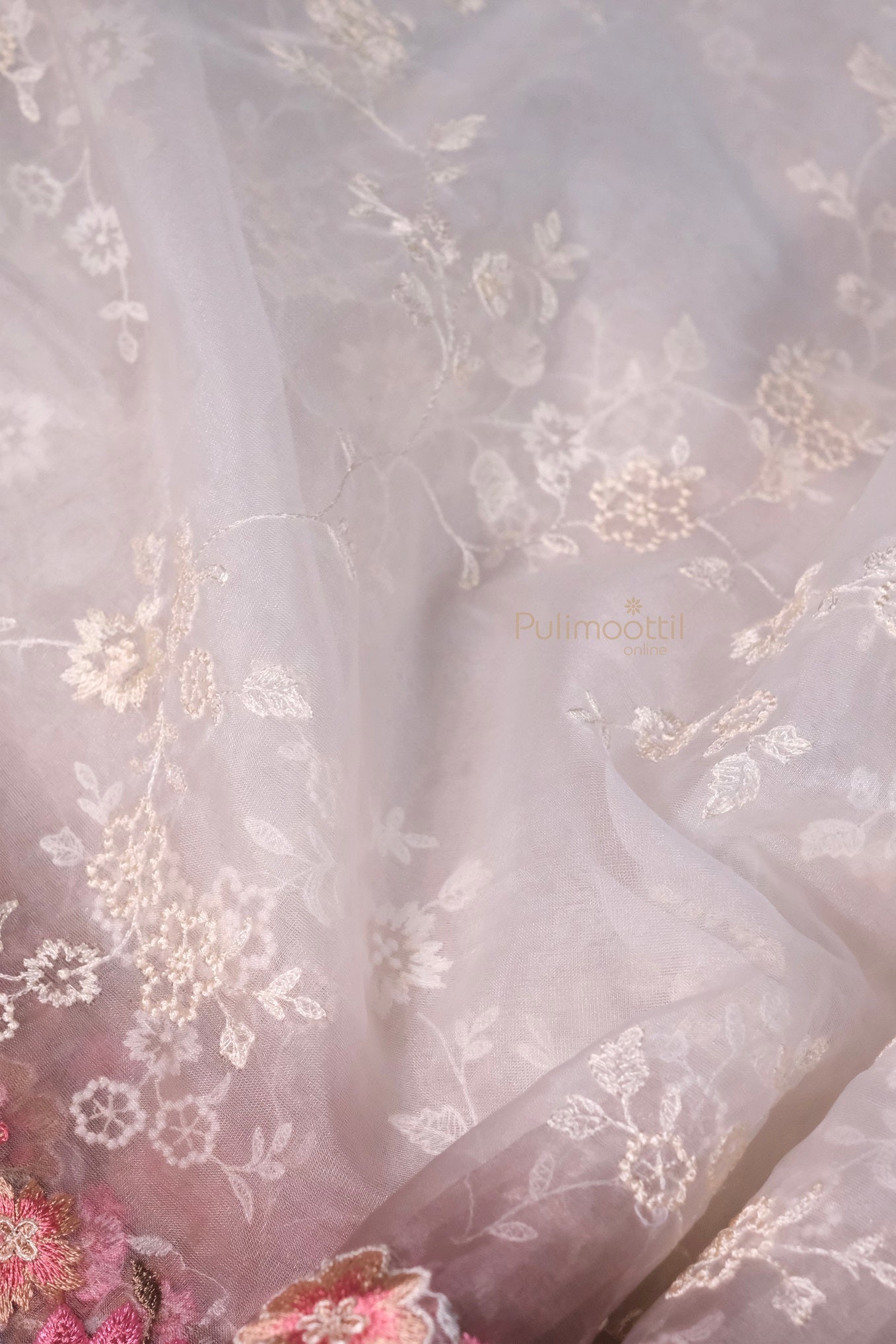 A soft side pose reveals the airy flow and luxurious fall of the fabric. The subtle border detailing enhances the saree’s structure, offering a refined silhouette that's both modern and rooted in tradition. A must-have for your designer collection.
