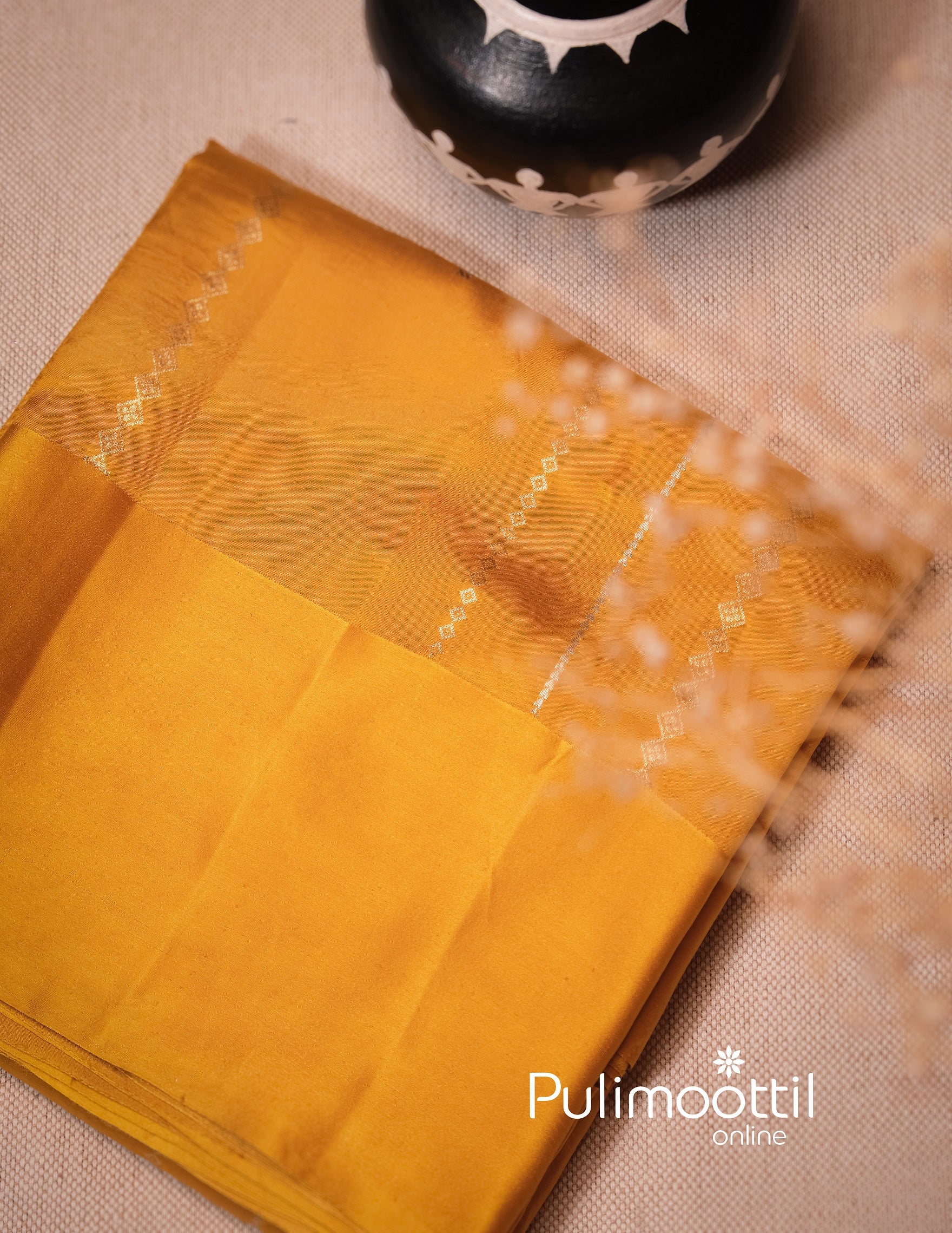 Folded yellow mango silk saree with subtle zari border, perfect for bridal Haldi ceremony or traditional Indian wedding