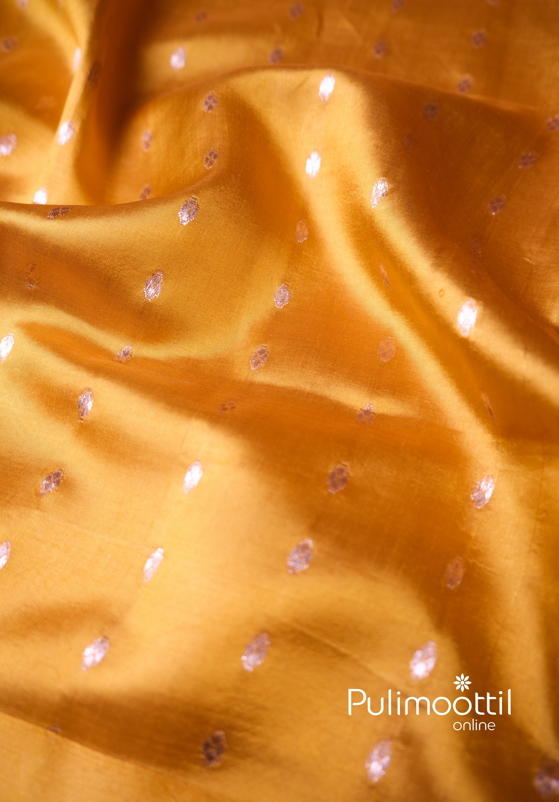 Glossy yellow silk blouse fabric with zari dots, ideal for bridal haldi or vibrant wedding day styling.